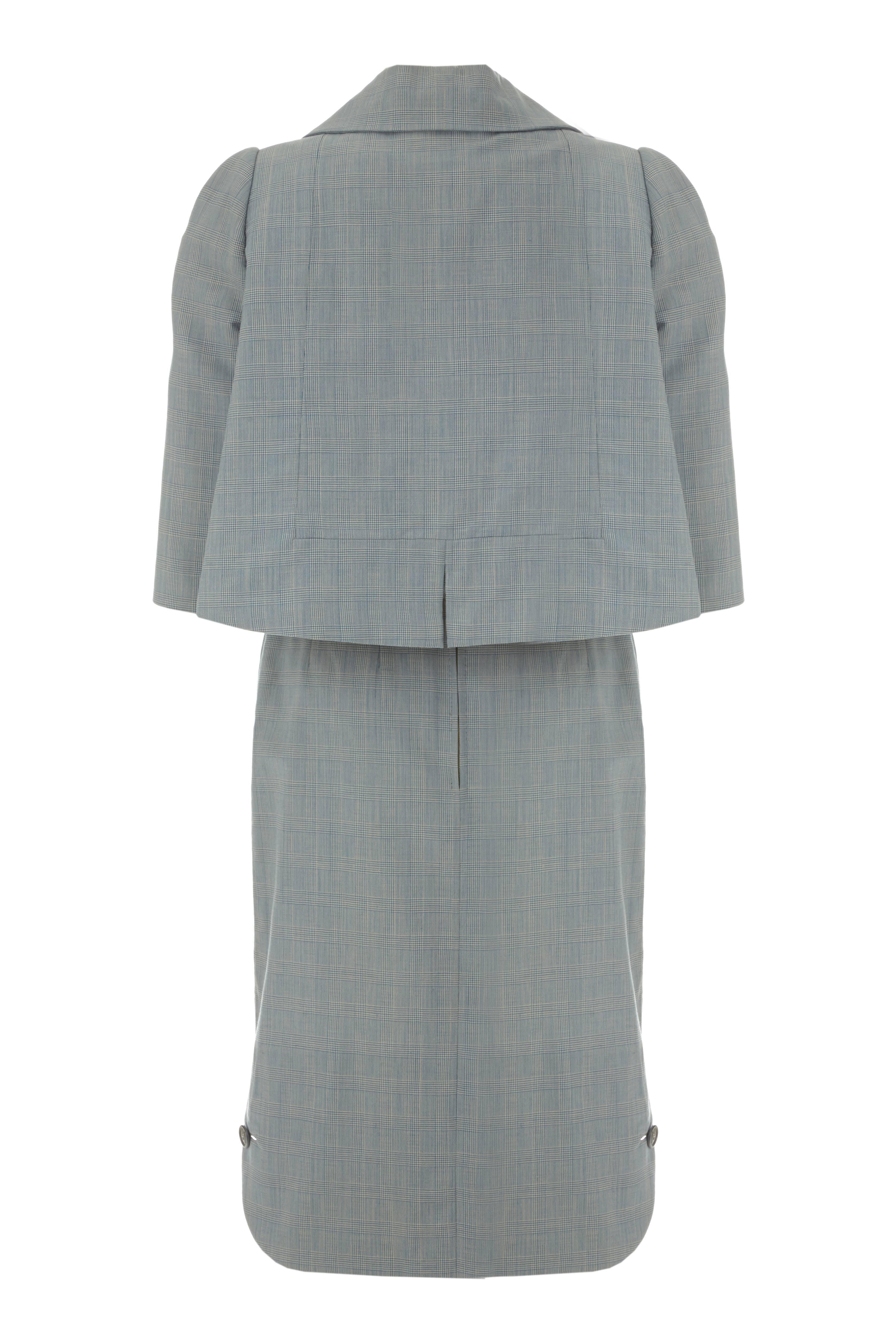 Vintage 1960s James Galanos blue Prince of Wales check fine wool suit consisting of a soft tailored jacket over a sleeveless dress.  A superb example of Hollywood couture this classic 60s suit is fully of quirky details with huge pockets at the