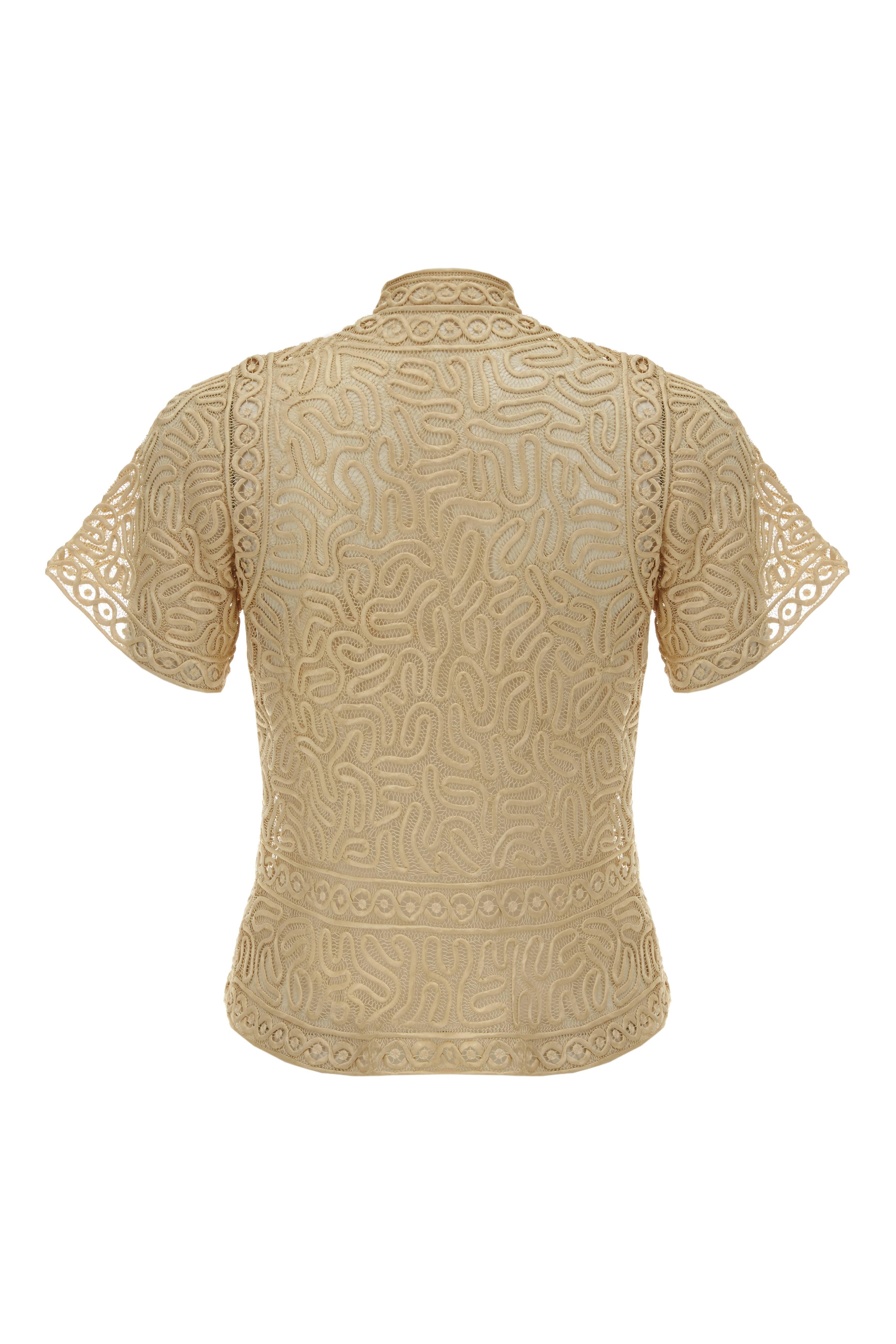 This is an exquisite tape lace blouse from the late 1920s/ early 1930s in handmade taupe silk lace with swirling ribbon and oriental style toggles to fasten down the front. It also features a mandarin collar and is in excellent condition with no