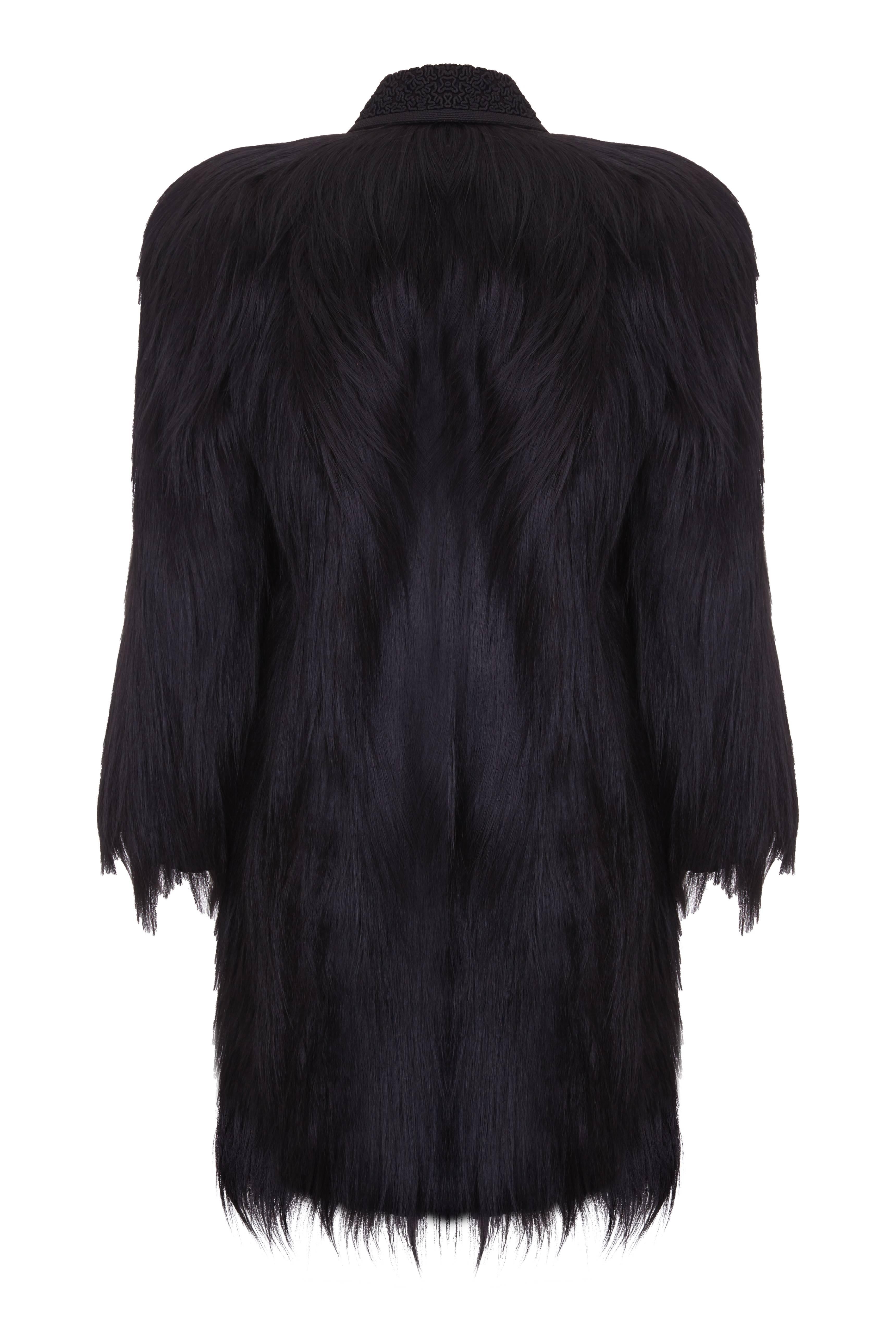 A beautiful vintage black colobus monkey fur coat with black soutache embroidered collar in truly excellent condition.  This pieces features exaggerated padded shoulders in typical 40s style and ¾ sleeves which fasten all the way up with poppers and