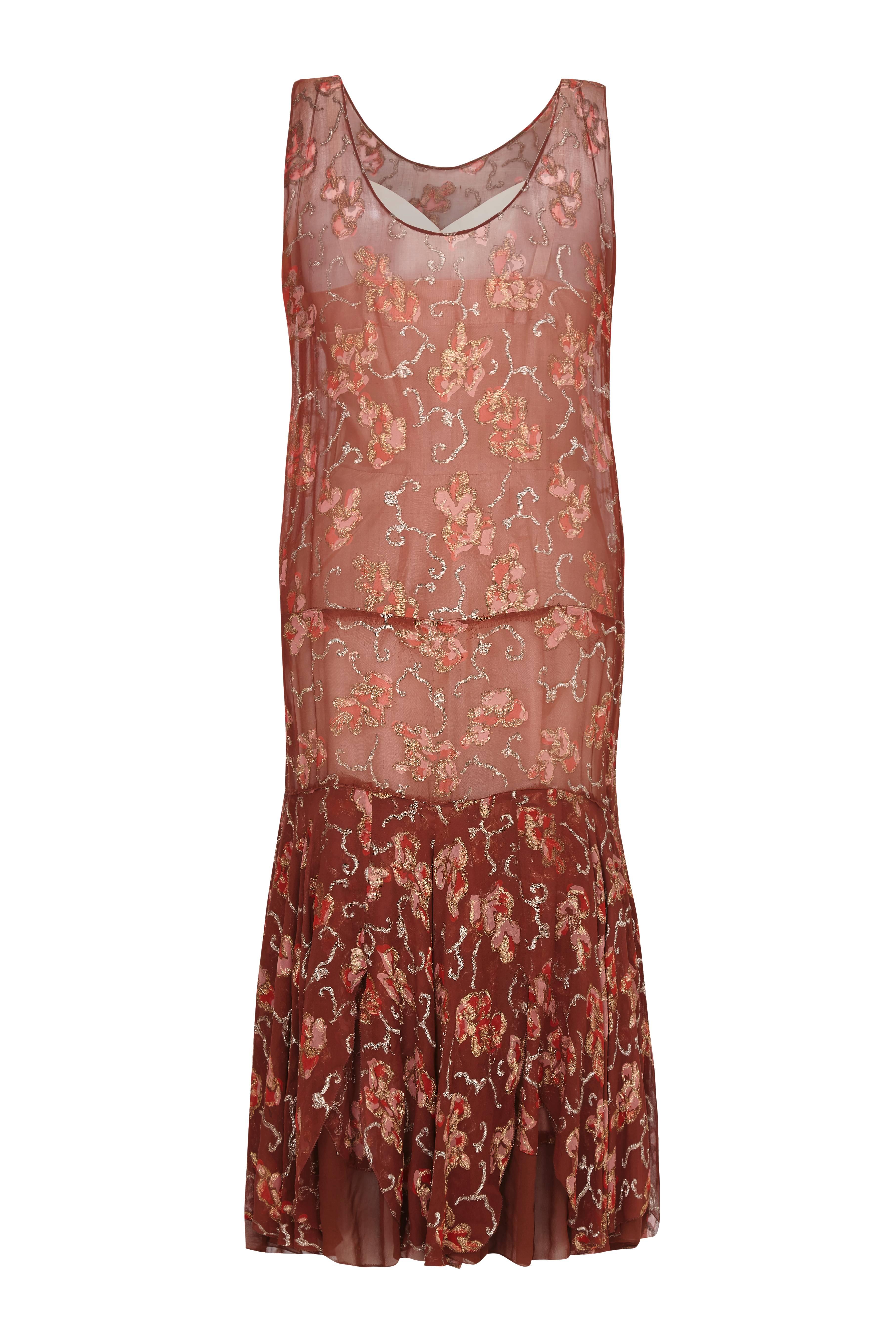 Beautiful 1920s vintage flapper dress with pretty pink petal print and gold thread embroidery.  This silk chiffon dress features the  classic dropped waist and has pin tucking detail to the front.  Due to the loose fitting flapper style it could