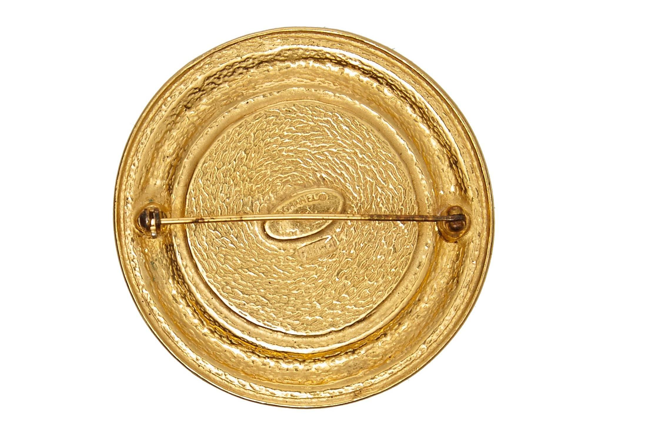 A stylish 1980s Chanel gold plate medallion brooch with the front door details of the Paris boutique where it all began at 31 Rue Cambon.  Signed with the Chanel oval cartouche on the back, made in Paris and numbered 1150.  The brooch is medium