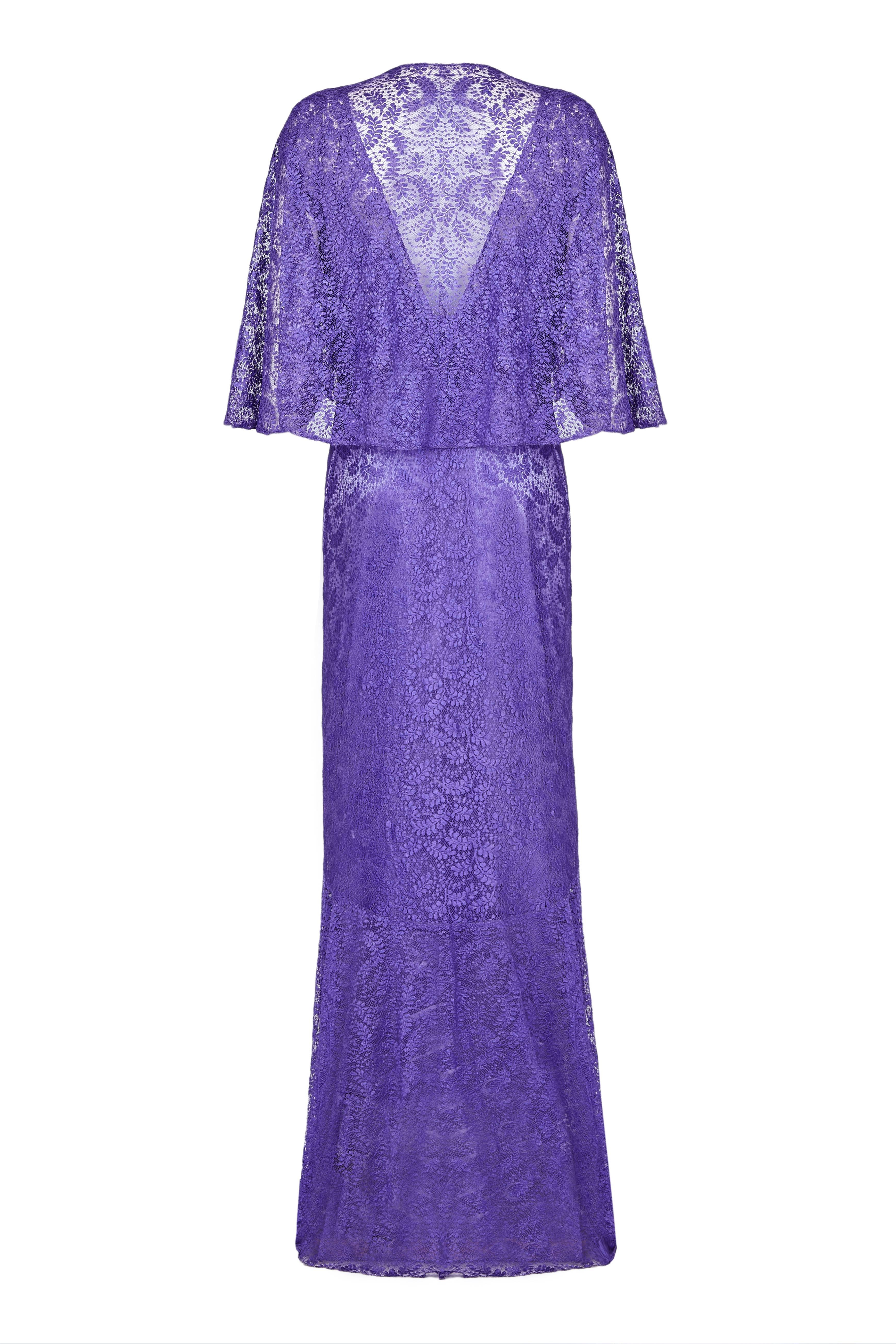 Stunning full length vintage 1930s lace dress in a striking purple with matching caplet/ bolero and original attached slip. It features pretty shaping around the bust, deep V back and kicks out at the bottom of the skirt.  A beautiful piece in