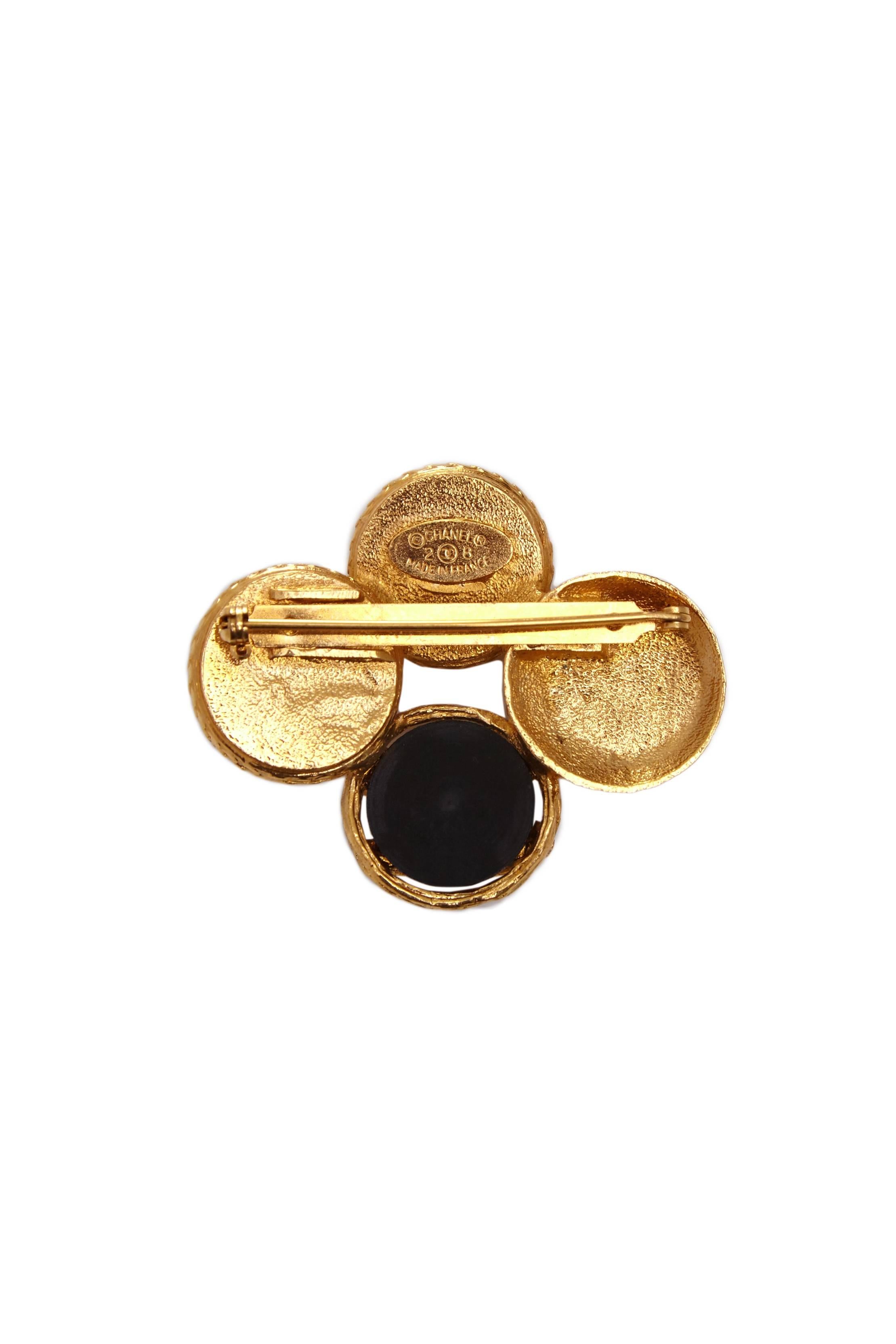 Classic Chanel in style this vintage 1990s brooch is made up of four discs joined together in black and gold tone metal.  On the back it is stamped season 28 dating it to 1993.  In excellent condition with no flaws to mention and comes with Chanel