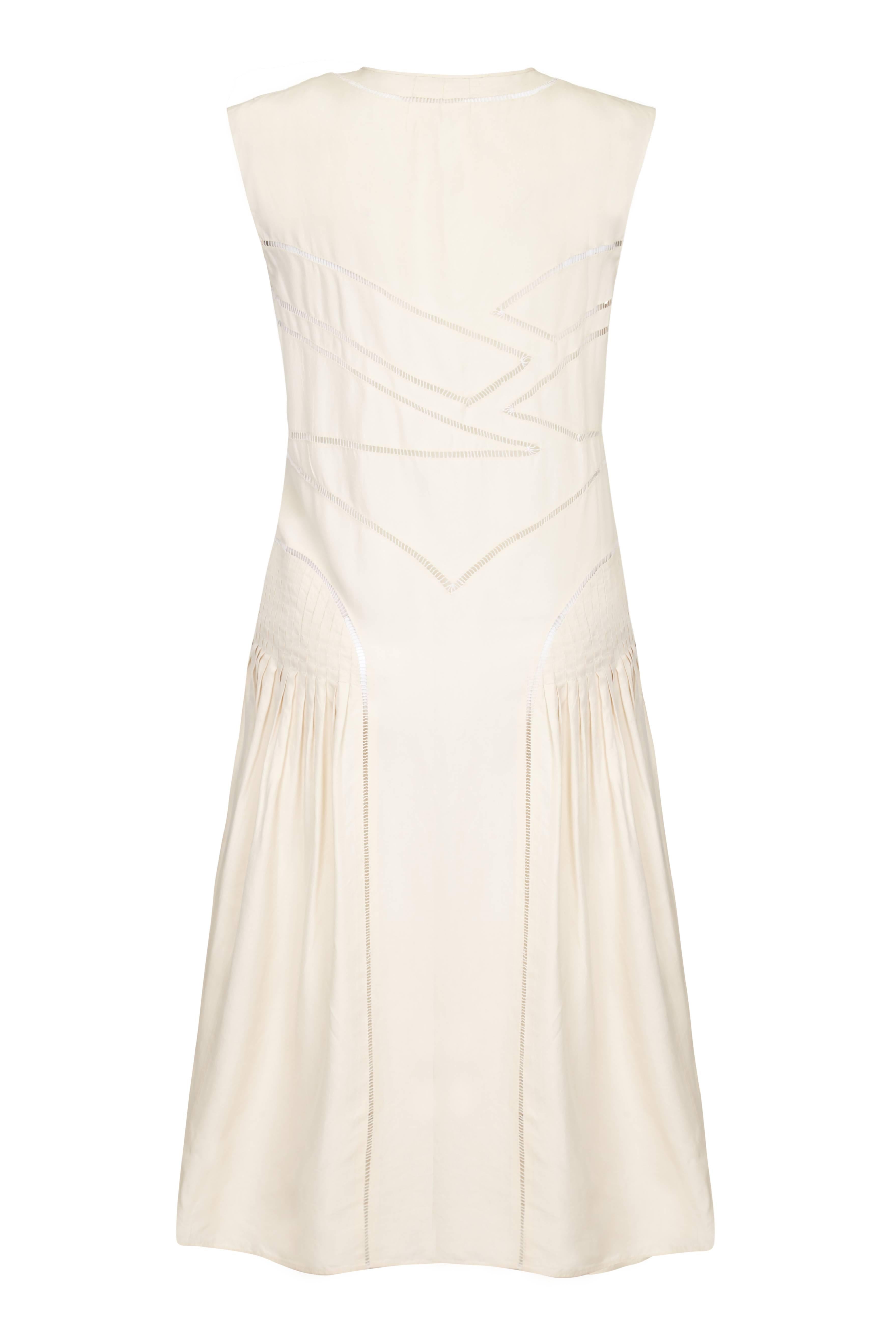Beautiful little vintage 1920s ivory silk dress with amazing cut out detail which is all done by hand and stitched pleats at hip level to add extra volume to the skirt.  This sleeveless, V neck dress is typical flapper style and is not fitted at the