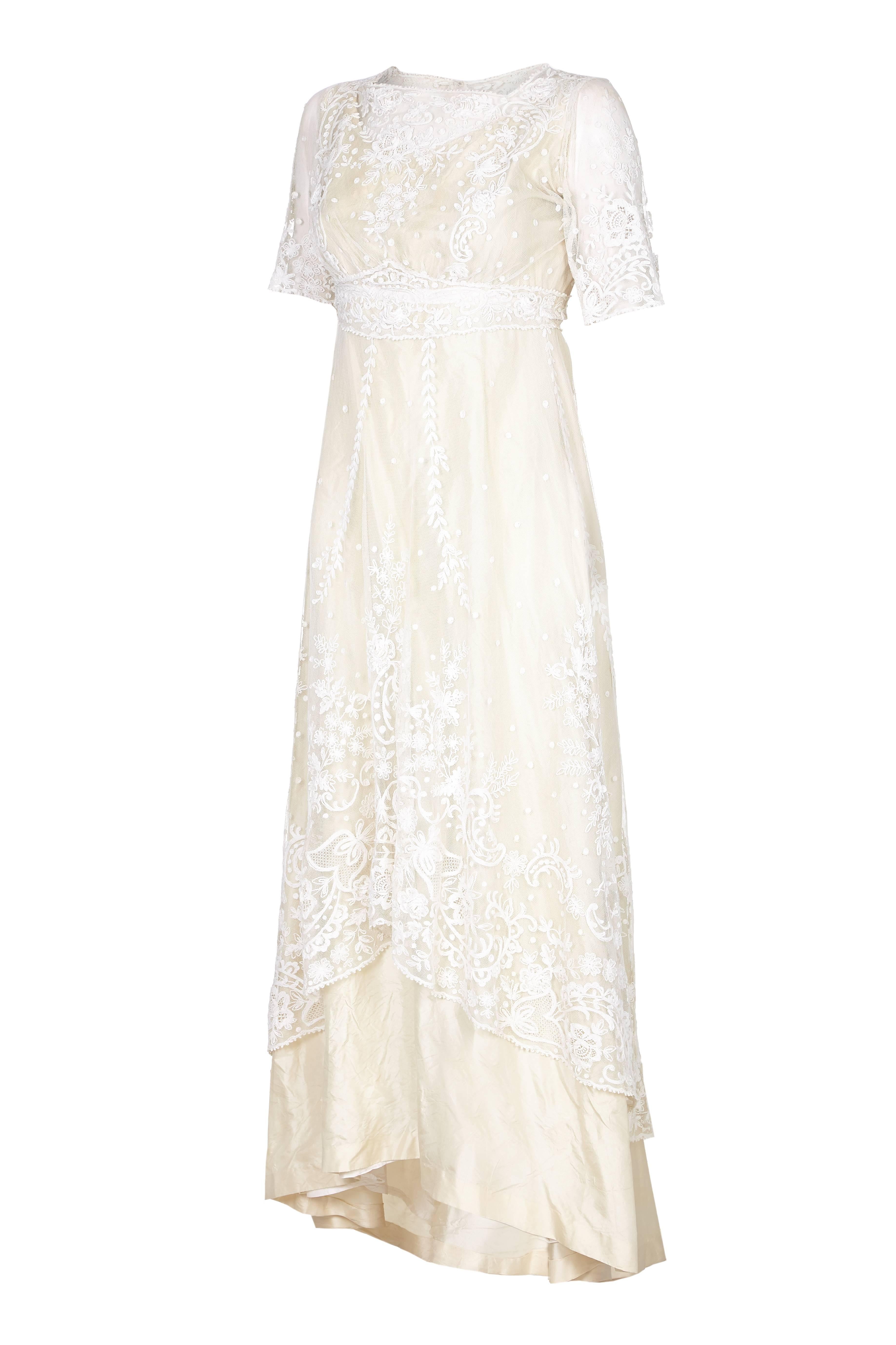 Exceptional and incredible vintage Edwardian wedding dress with amazing top layer of hand made lace featuring floral designs.  The lace looks to be Brussels and/or tambour lace applied to machine-made net and both bobbin and needle lace motifs.