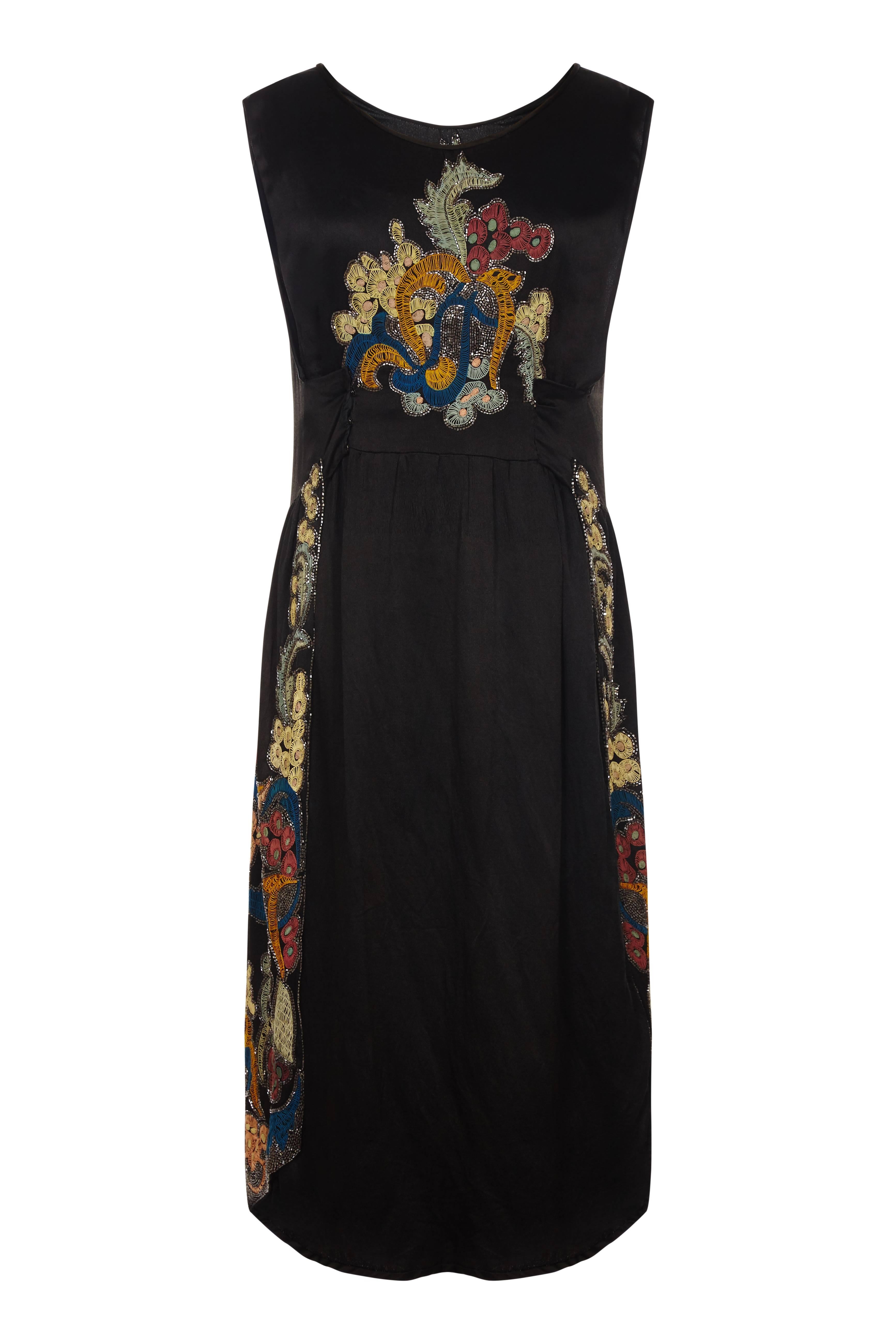 This haute couture Doeuillet exquisite 1920s silk beaded flapper dress is a rare find and in superb condition.  Of black silk charmeuse with immaculate surface detail and heavily embroidered by the House of Lesage.  The oriental style flora motif is