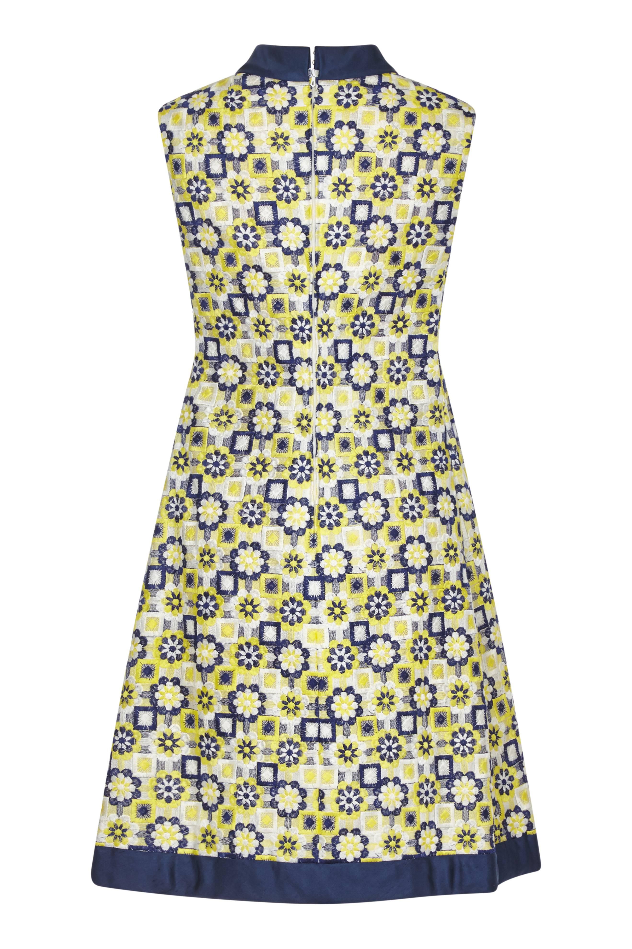 This unique 1960s Blue and Yellow embroidered shift dress has plenty of character and is a charming example of 1960s modernity. The machine embroidered cotton overlay is a flattering combination of floral and geometric design, in cheerful yellow,