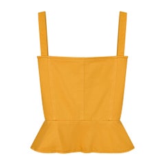 Top a corsetto in cotone giallo Yves Saint Laurent, presentato in passerella nel 1980