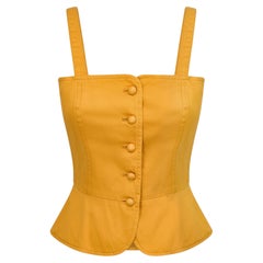 Top a corsetto in cotone giallo Yves Saint Laurent, presentato in passerella nel 1980
