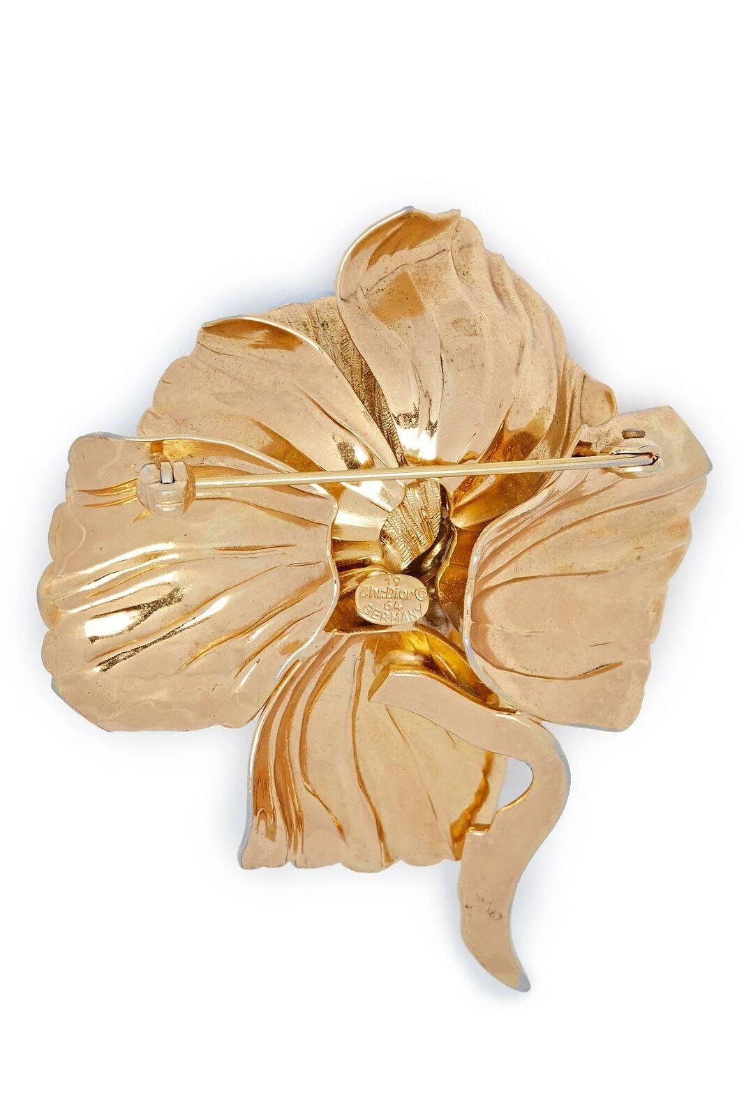 1964 Christian Dior gold tone sculpted rose design brooch with C pin fastening.  This piece is marked 1964 on the cartouche on the rear. This brooch was a classic design and was reproduced many times by the factory Henkel & Grosse for Dior.

In