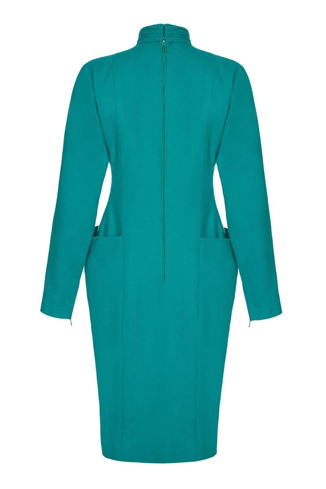 1980s Nina Ricci boutique label, emerald green wool long sleeved dress.  Ruched high neck collar and pleated waist line together with the panelling and front pockets give the dress a stylish feminine look. A versatile piece that could be worn during