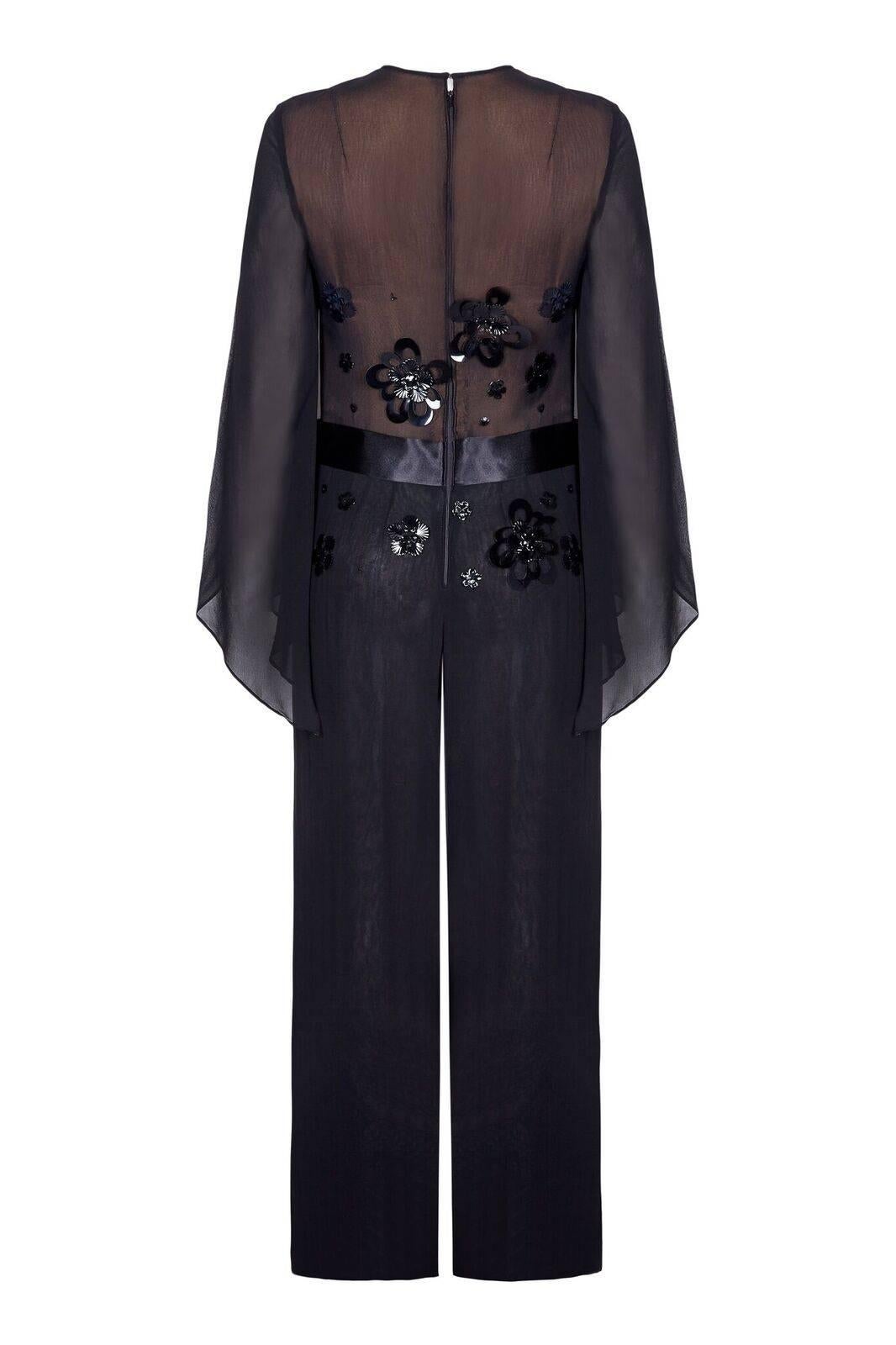 This stunning vintage 1970s black chiffon jumpsuit with sequin embellishment boasts some unique and exciting design features. Couture made by Pauline of Northwood, the black chiffon overlay is fully lined from the waist down with an additional layer