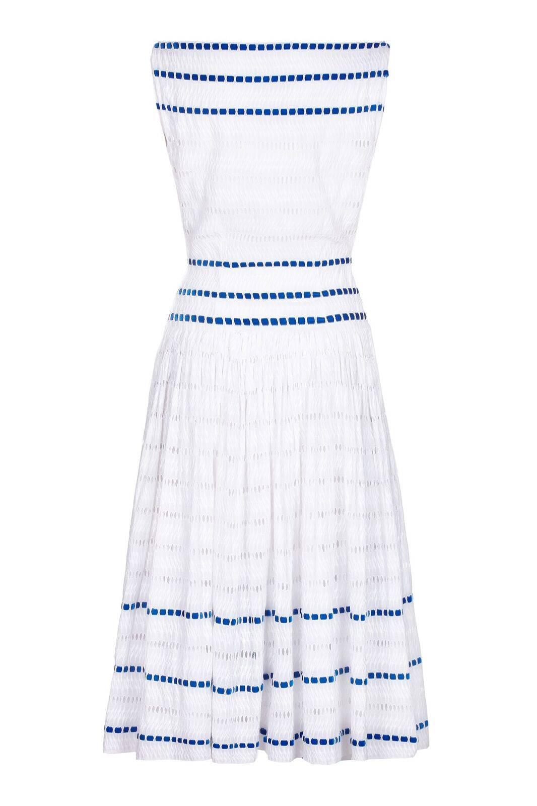 This enchanting vintage 1950s white broderie anglaise dress with blue velvet ribbon work is a beautiful fit for an hourglass figure. The slash neckline perfectly balances the ankle length skirt which flares out from the hip into soft pleats. Neat