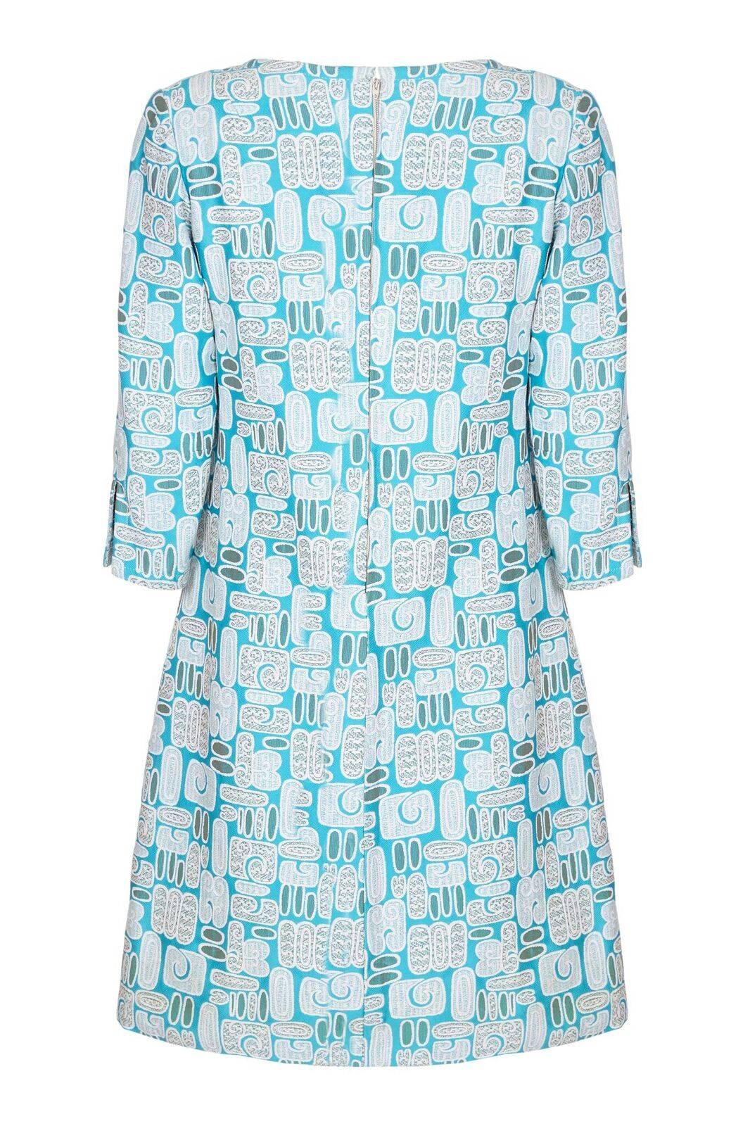 This beautiful 1960s Larry Ross dress in silk brocatelle fabric was once owned by Dame Vera Lynn and comes with a certificate of ownership. The fabric design is made up of soft geometric patterns in radiant turquoise, eggshell blue, and cream. The