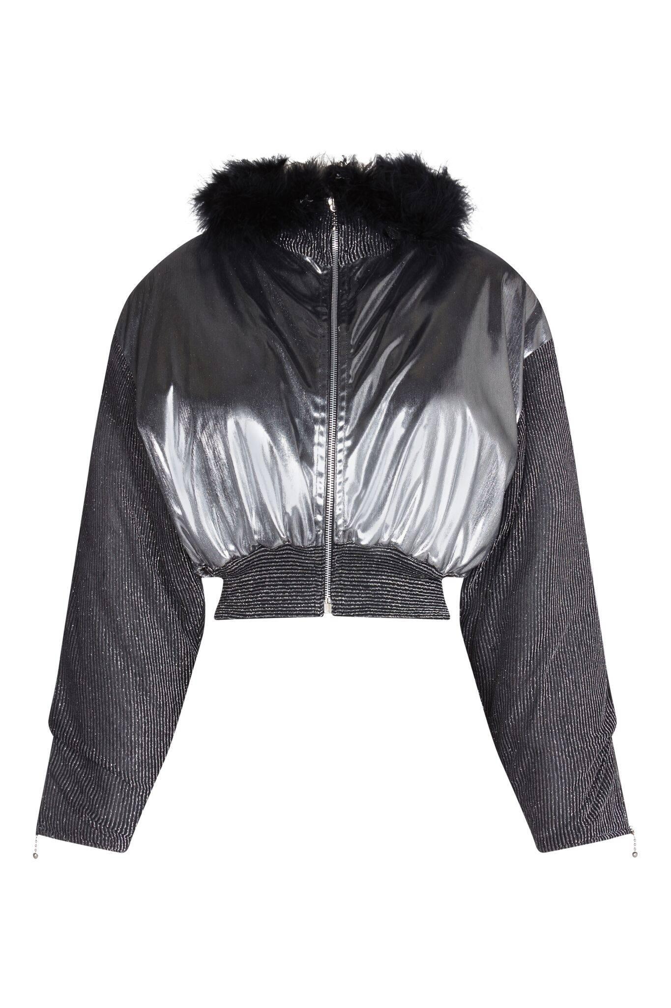 This striking 1980s silver hooded jacket is in superb condition and makes a wonderful statement piece. The metallic, liquid silver effect fabric has a futuristic feel whilst the sleeves, hooded collar and waistband are of a finely ribbed black and