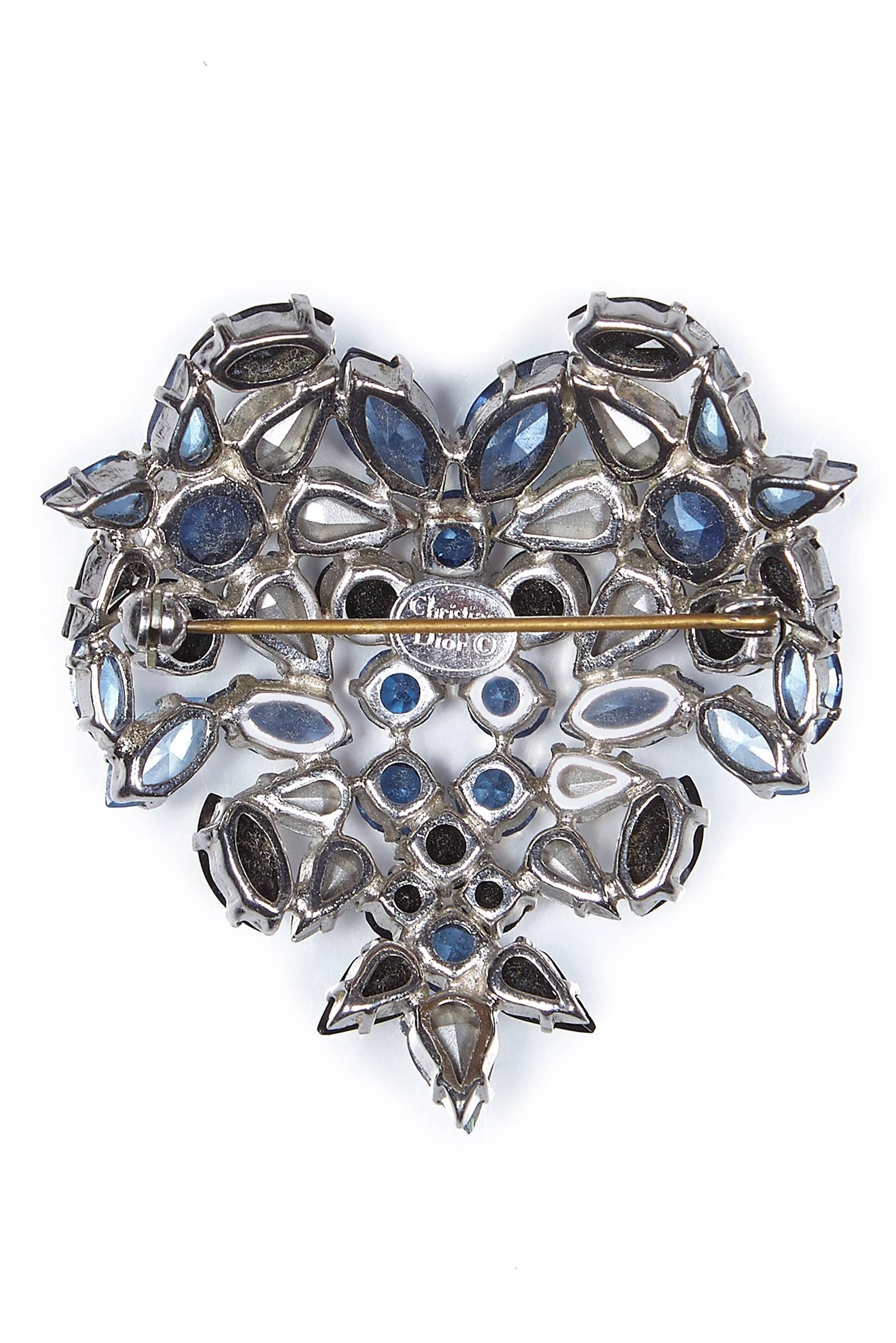 This ornate 1950s Christian Dior heart-shaped Swarovski crystal brooch is a fully documented and sort after design by Henkel and Grosse circa 1958.  The exquisite prong-set marquise, pear and round-cut rhinestone crystals are arranged in a heart