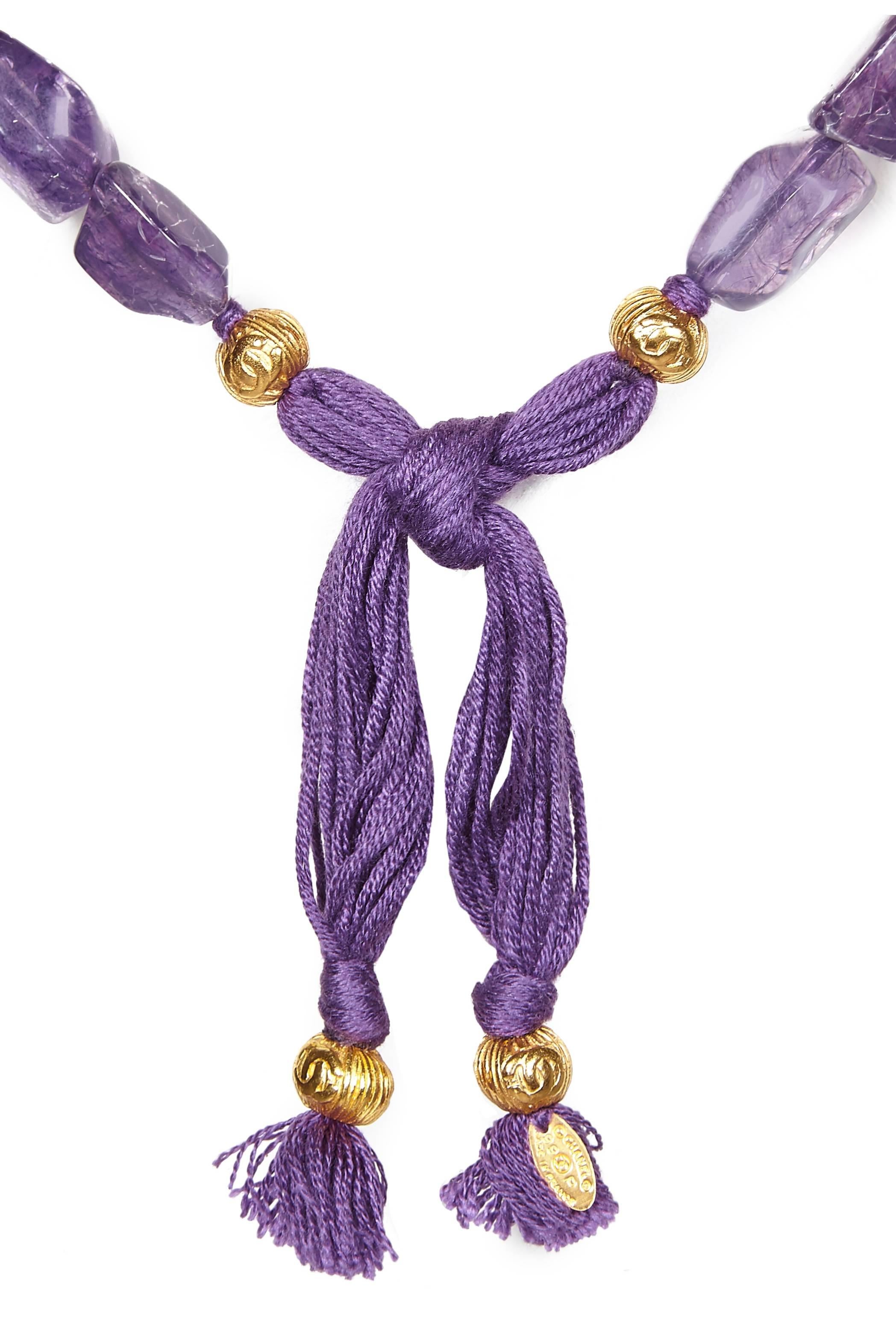 This statement, extremely long, Chanel necklace / belt circa 1999 is in excellent condition and comes in the original Chanel box. The beads are a combination of gold gilt rondelles emblazoned with the signature CC motif and irregular-cut faux