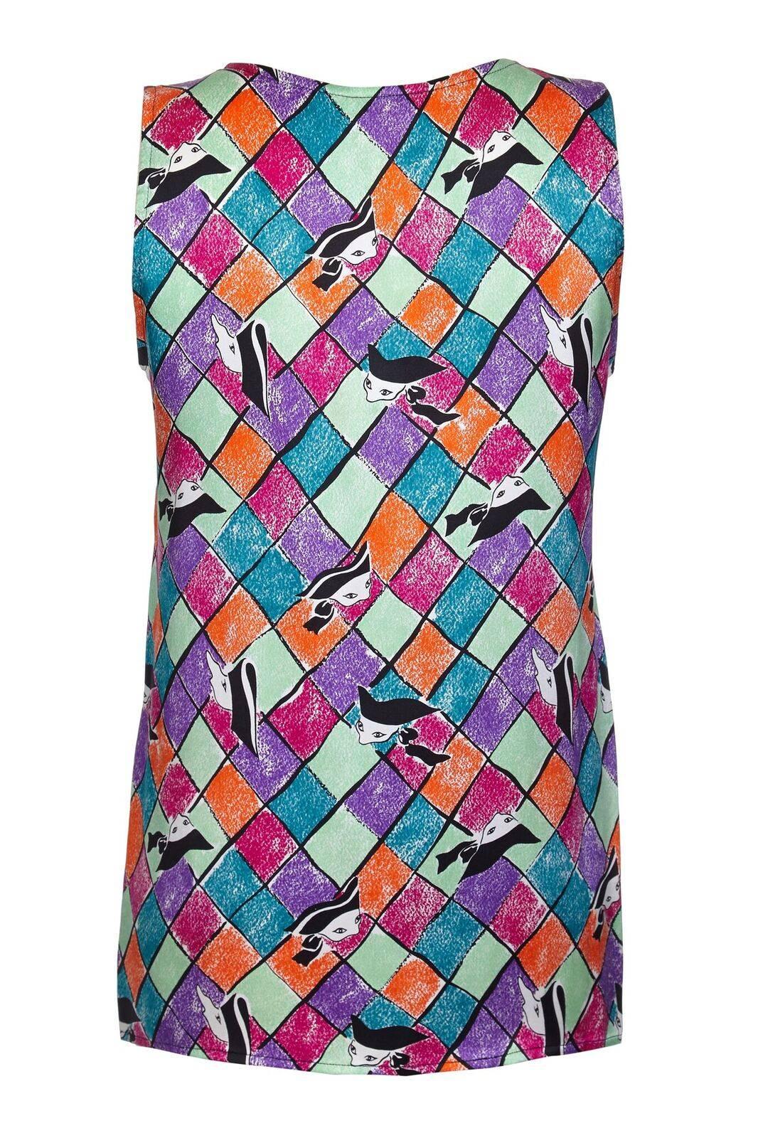 This vibrant and colourful late 1980s early 1990s Yves Saint Laurent silk top is in pristine condition and beautifully cut. The playful abstracted harlequin print in dark pink, purple, orange, mint green and turquoise give this piece a playful and