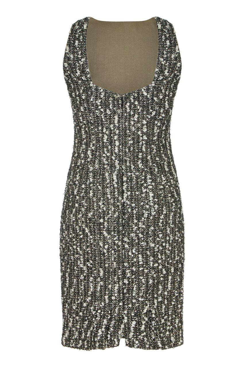 This stylish Chanel 2004 season fantasy tweed dress is a blend of silver/white, charcoal and ash grey interwoven with a thin silver lame thread and fully lined in soft sage/ash coloured silk. The simple line is tailored beautifully over the bust and