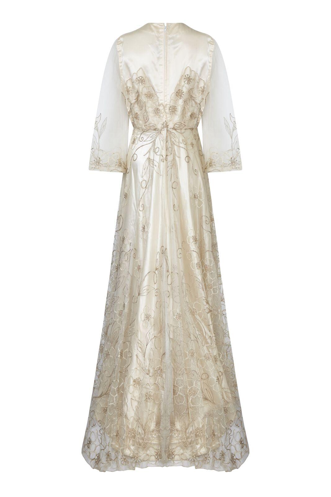 This enchanting late 1950s wedding dress in warm ivory with delicate floral embroidery is in superb condition and has a simple feminine silhouette. The thick sateen underlay is a sleeveless shift cut with a modest round neck, neatly synched at the