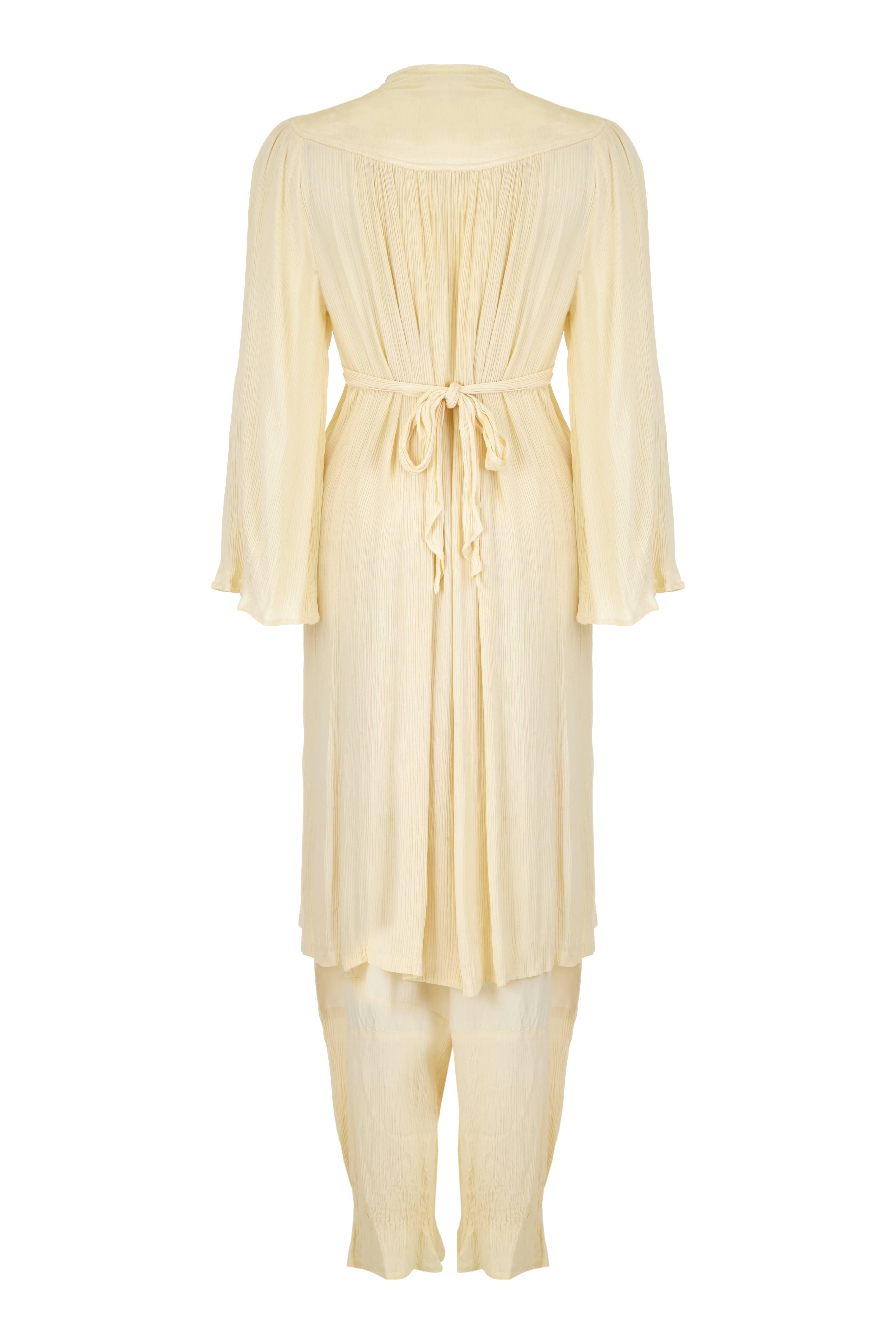 Lovely vintage 1970s Ossie Clark for Radley cream pleated tunic and trouser set.  This easy to wear, relaxed suit features a yoke at the back which wraps around to the front to form an panel that extends to bust level where ties are attached to tie