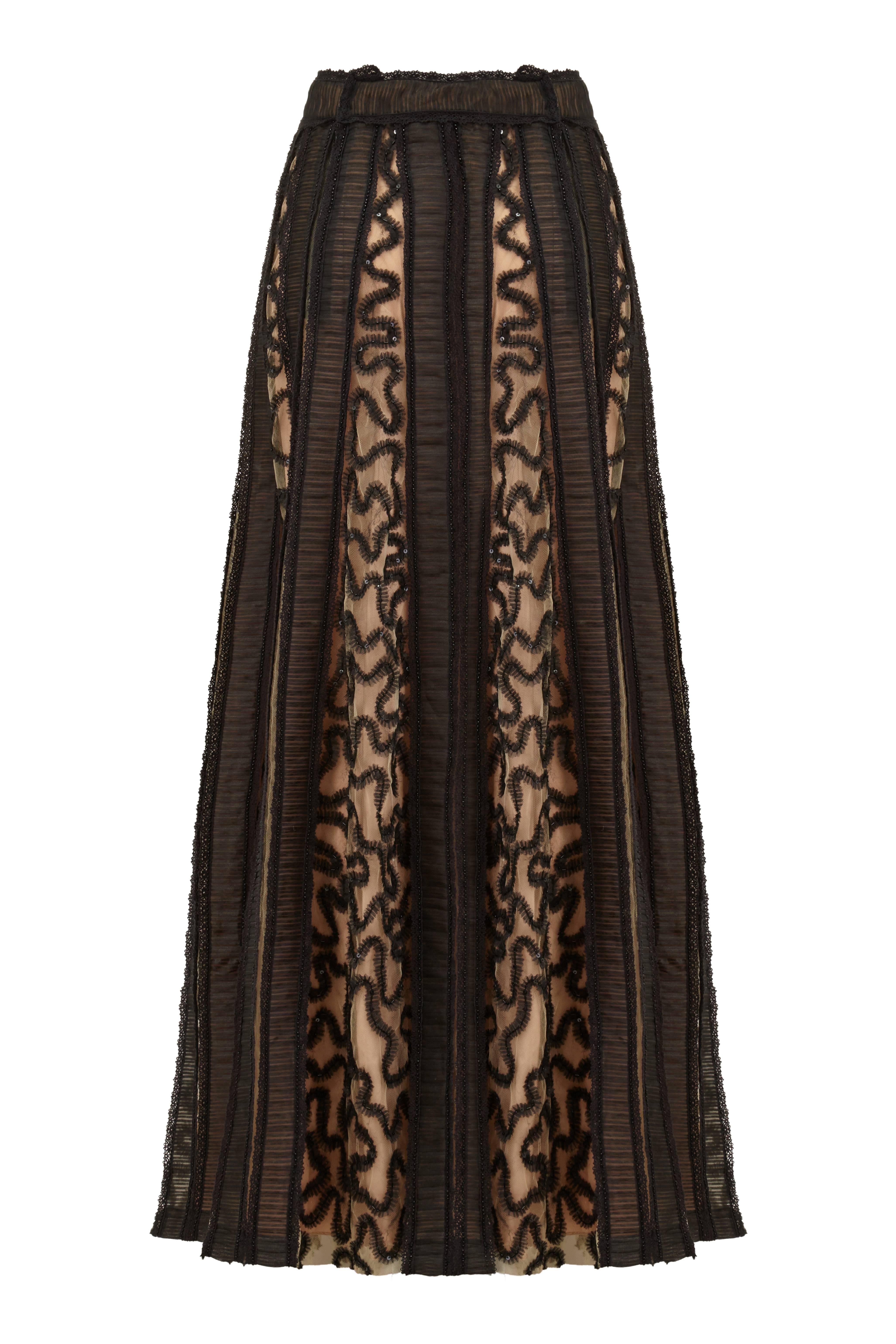 Sensational full-length flared vintage couture skirt by Bill Blass for Saks 5th Avenue.  This piece consists of a net over skirt, which is split in to panels defined by stripes of horizontal finely pleated organza with black beads and sequins and