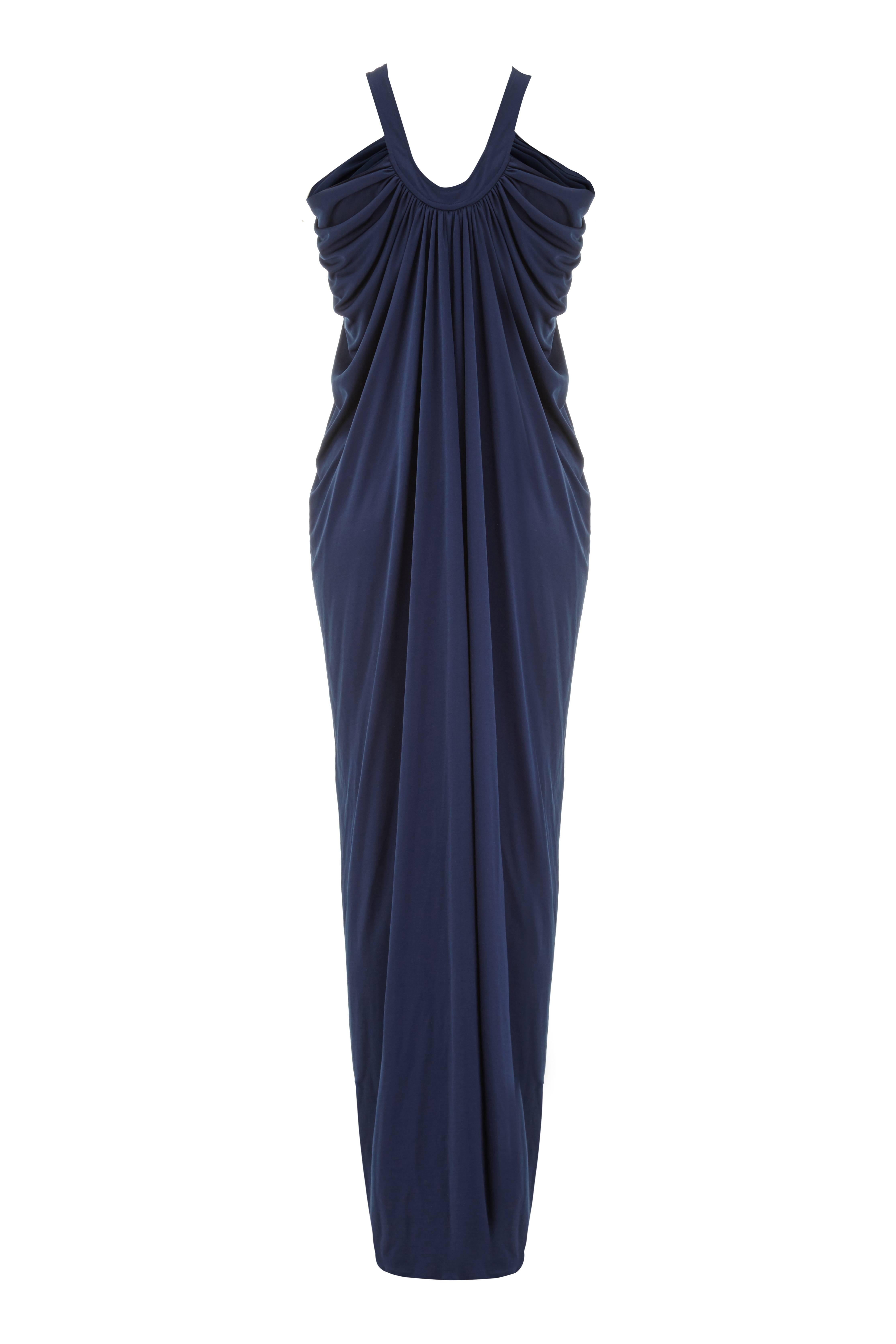 Gorgeous draped navy jersey vintage 1970s dress by Yuki for Rembrandt.  This full length evening dress features an opening at the bust and hook and eye closures on the neckline.  As it is not structured it would fit a variety of sizes but would
