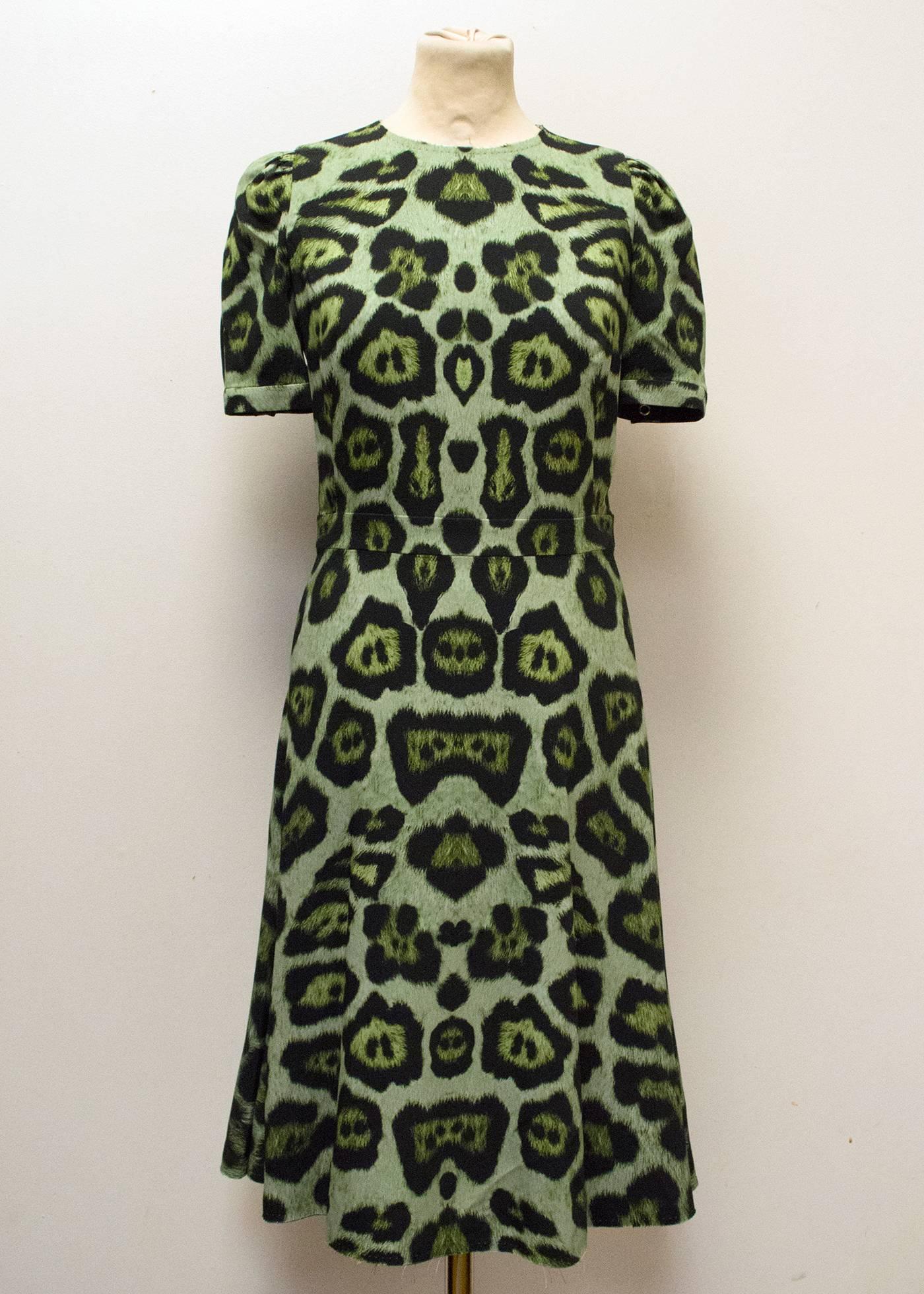 Givenchy green leopard print dress with distressed hem.

Features dome button on both sleeves, a round-neck and hidden back zipper.

The dress is in excellent condition and fits a UK size 10. The mannequin and seller are UK size 10.

FR38