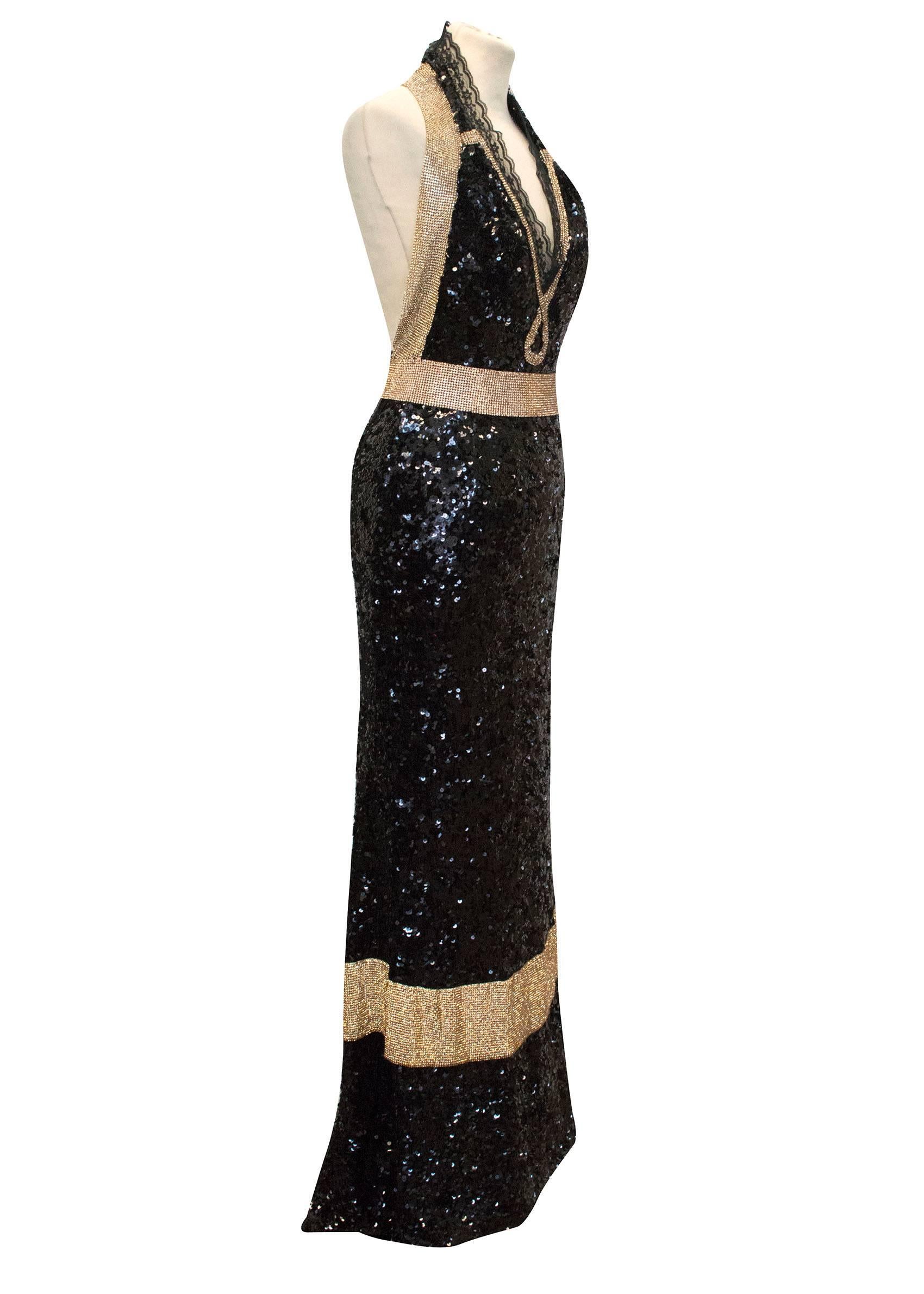 Dolce & Gabbana Bespoke Black and Gold Halter Neck Evening Gown is designed in a halter neck style with black sequins and 5cm thick gold crystal bands along the halter neck strap to the back, along the centre front bust, around the waistline and