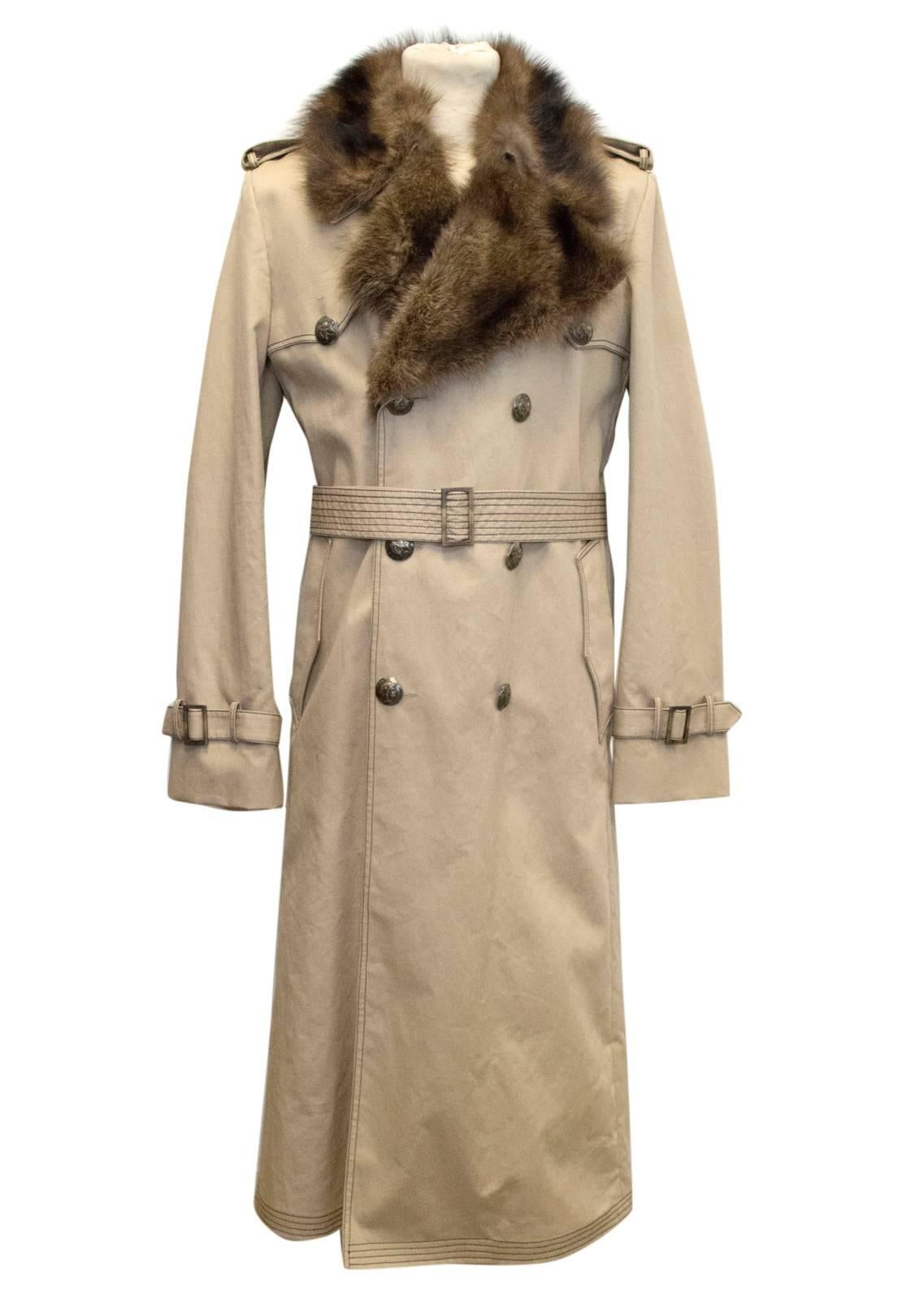 Fendi men's beige trench coat with black stitching and detachable brown wolf fur collar. Features large antique style brass buttons with Roman soldier / Fendi logo motif. Coat is heavy weight and semi lined with an additional sheared beaver fur,