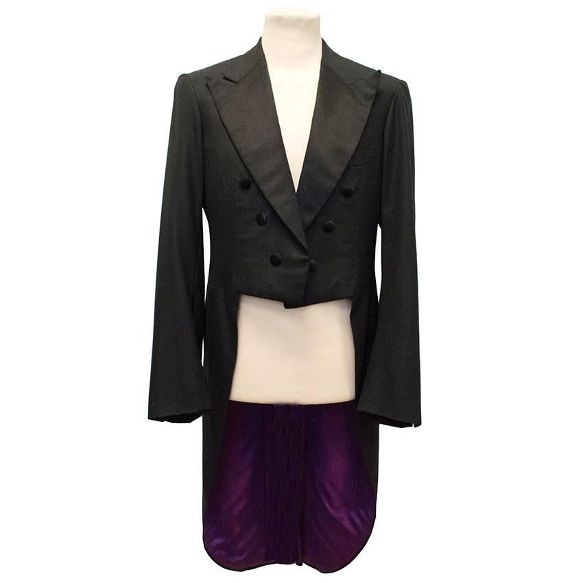 Kiton black wool tailcoat featuring peaked lapels, interior and exterior pockets and button detailing on the front. The tailcoat is fitted, medium weight and fully lined in a contrasting purple silk with a single vent at the back. Size 48, drop