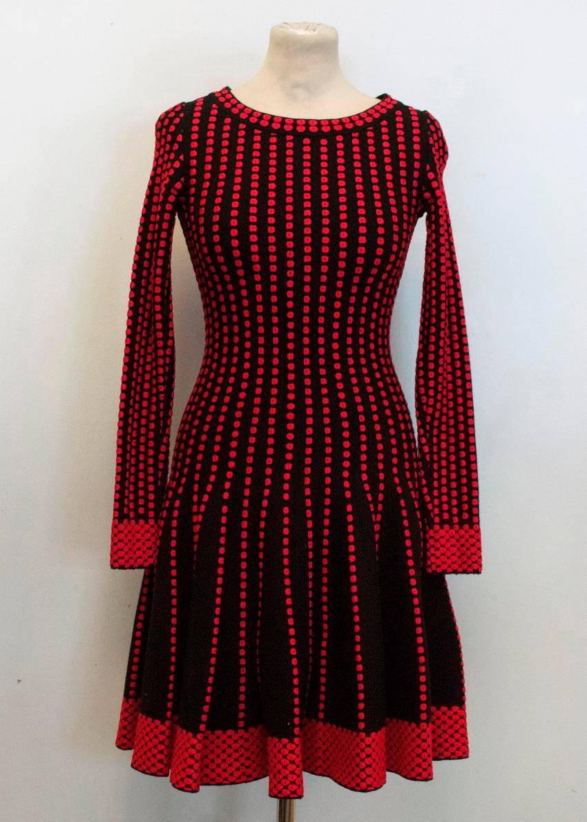 Alaia black skater dress with red dot embroidery design. Long sleeves with jewel neckline and back zip fastening. Medium to heavy weight.

- Made in Italy
- Dry clean only

Condition: 10/10

FABRIC: 65% WOOL, 15% VISCOSE, 10% POLYESTER, 8%
