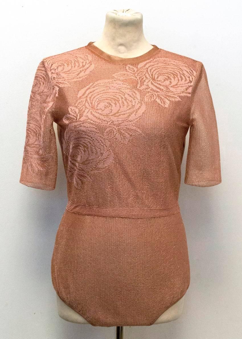 Vionnet mesh bodysuit with embroidered roses and high neck. Item has rouleau loop and button fastening at the top of the back, rest of back is open, has three popper fastening at the bottom and an invisible zip fastening at the side. Item has 3/4