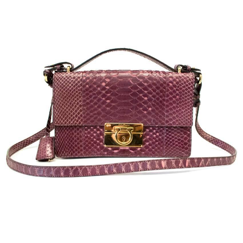 Salvatore Ferragamo plum python skin 'Aileen' cross-body bag with gold hardware featuring a fold over top, flip lock closure, a front embossed logo stamp, a padlock fastening detail, a flat top handle, a hanging key fob, a detachable shoulder strap