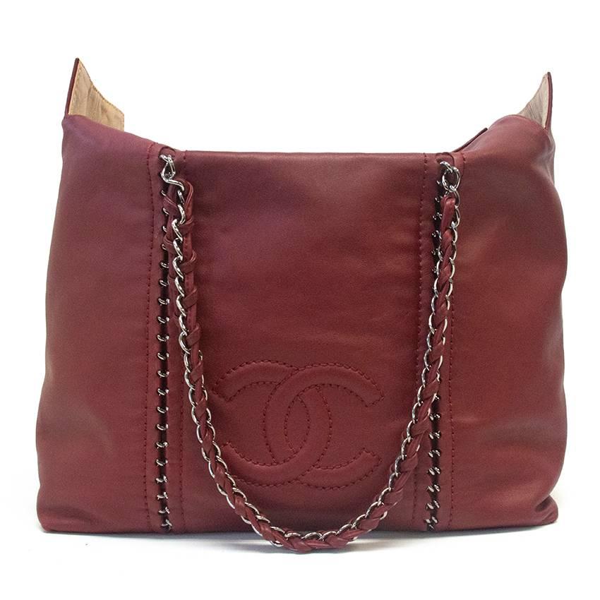 Large red Chanel handbag with logo stitching on the front, Chanel logo charm on the zipper and chain details on the bag and handles, authenticity card is in the inside pocket. Some small scuffs on the leather but this does not affect the beauty of