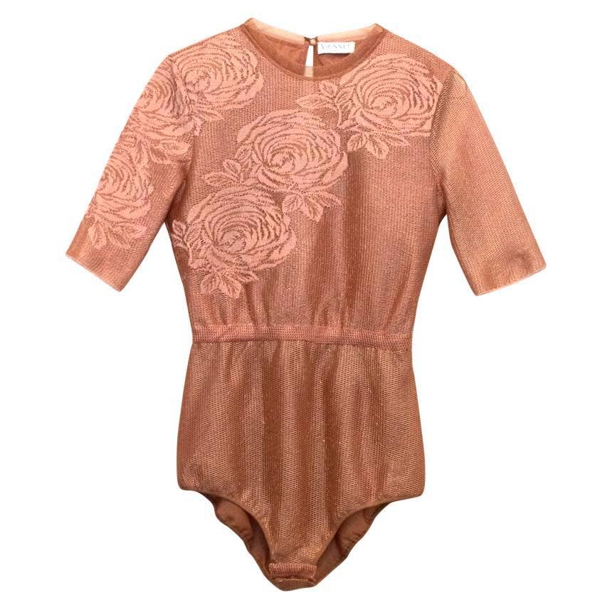 Vionnet mesh copper bodysuit embroidered with roses. The bodysuit is slim fitting and features a high neck, 3/4 length sleeves and elasticated waist for definition, rouleau loop and button fastening at the neck, back peephole and three popper