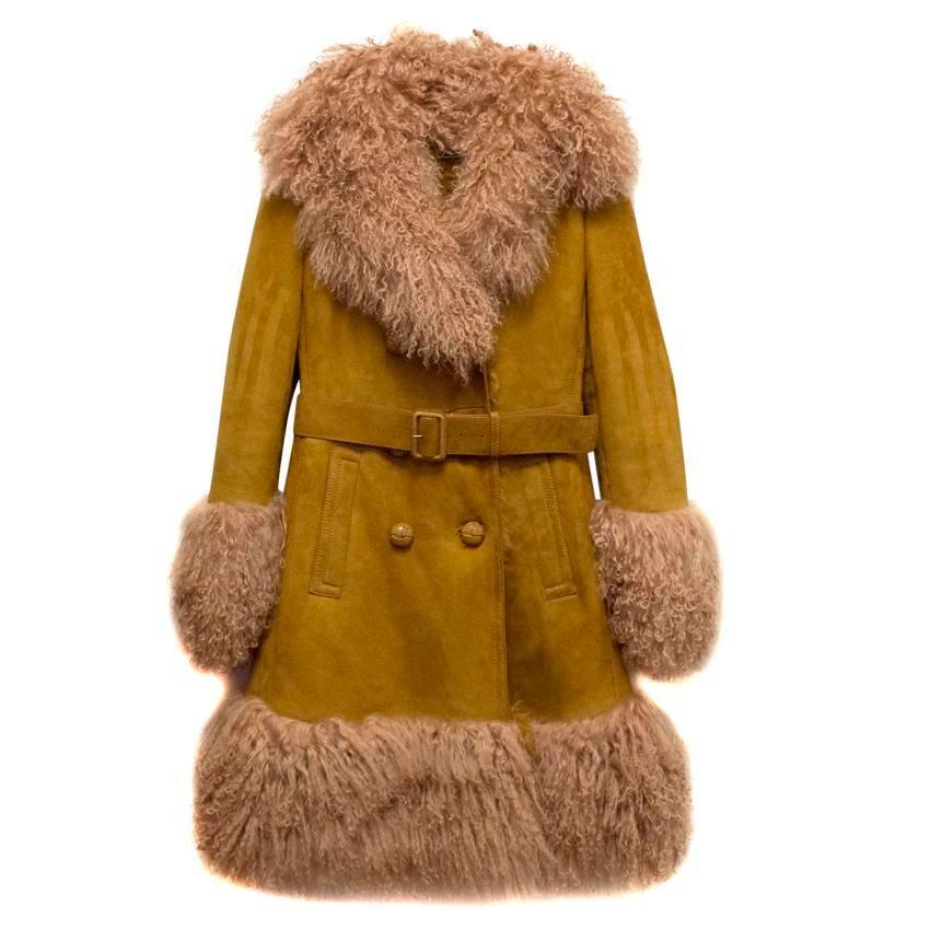 Gucci tan suede coat featuring beige shearling statement collar, cuffs and hem. The coat is heavy-weight, has a classic fit and is fully lined in tan shearling. Double breasted with button closure at the front and a tan waist belt with two