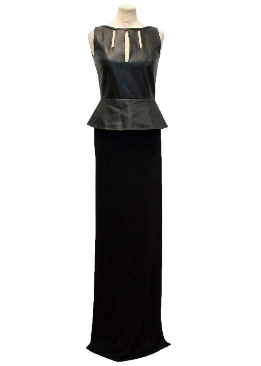 Osman black maxi dress featuring a long black skirt with a thigh high slit and a leather peplum top with three cut outs on the bust. Slim fitting and soft to touch. The dress is sleeveless, fully lined and has an exposed back zipper. AW12. US 4, UK
