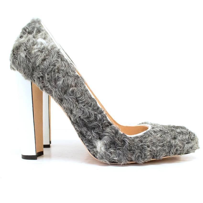 Manolo Blahnik shearling grey pumps featuring patent white block heels and white patent trimmings. Fully lined with leather and suede. 

Slight storage marks to the soles that cannot be seen when worn. 

Item comes with dust bag and original box.