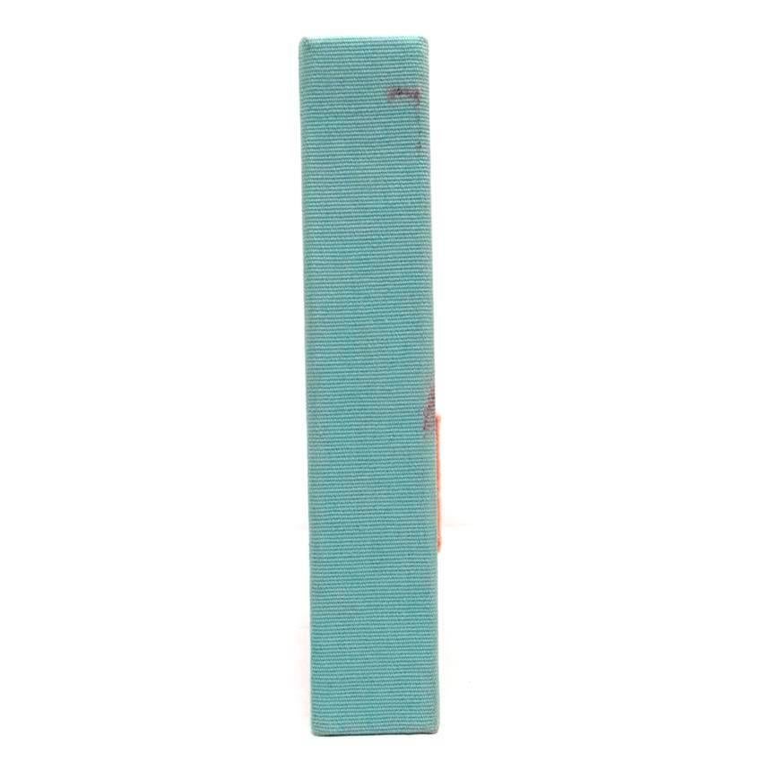 Olympia Le-Tan blue canvas book-shaped clutch bag that has written on the front, 