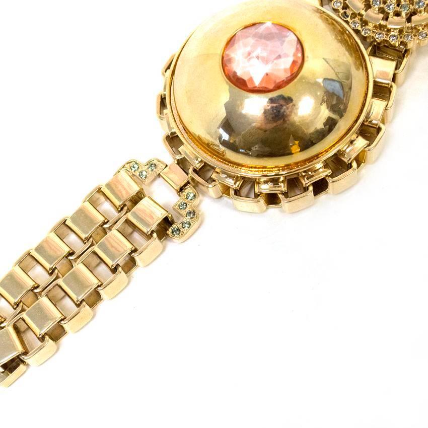 Mawi Gold & Crystal Chunky Bracelet. Double gold chain design with two exquisite pendents. One pendent includes crystals surrounding a pearl, and the other pendent is gold surrounding a beautiful pink gem. This is heavy in weight. 

Condition: