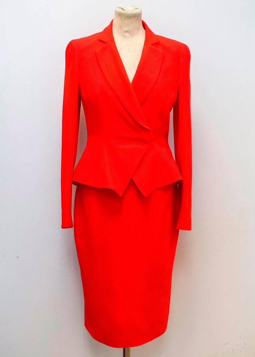 Alexander McQueen red, medium-weight, two piece suit. The blazer is slim fitting with a slight flare at the waist and features, padded shoulders, full length sleeves, peak lapel covered cuff buttons and a covered double breast. The skirt is fitted,
