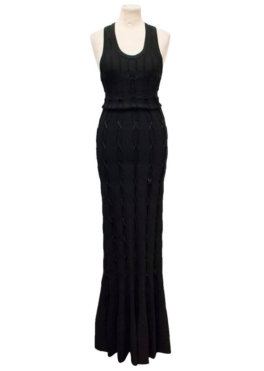 Alaia black sleeveless maxi dress with a flared fishtail hem. Features a lace design which tassels at the flared part of the dress.  The dress is heavyweight and has a concealed zip down the back of the dress. Size 36.

Condition -