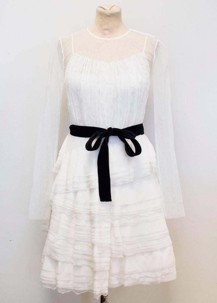 Alberta Ferretti cream tiered ruffled dress, with mesh, lace and translucent silk layers. The neckline, shoulders, sleeves and upper back are mesh. The dress is long sleeved with a high neck and is fitted at the bust with a tiered skirt and featured