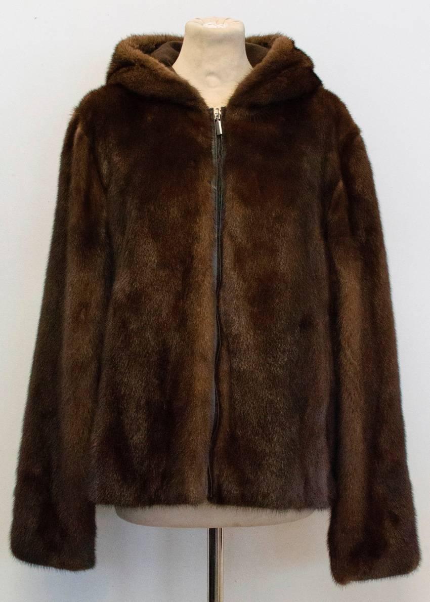Gerard Darel chocolate brown mink coat with cashmere lined hood and silk lining . The coat has a relaxed fit and is heavy weight and soft  to the touch with front zip closure and a hood. Two functioning pockets on the front of the jacket.