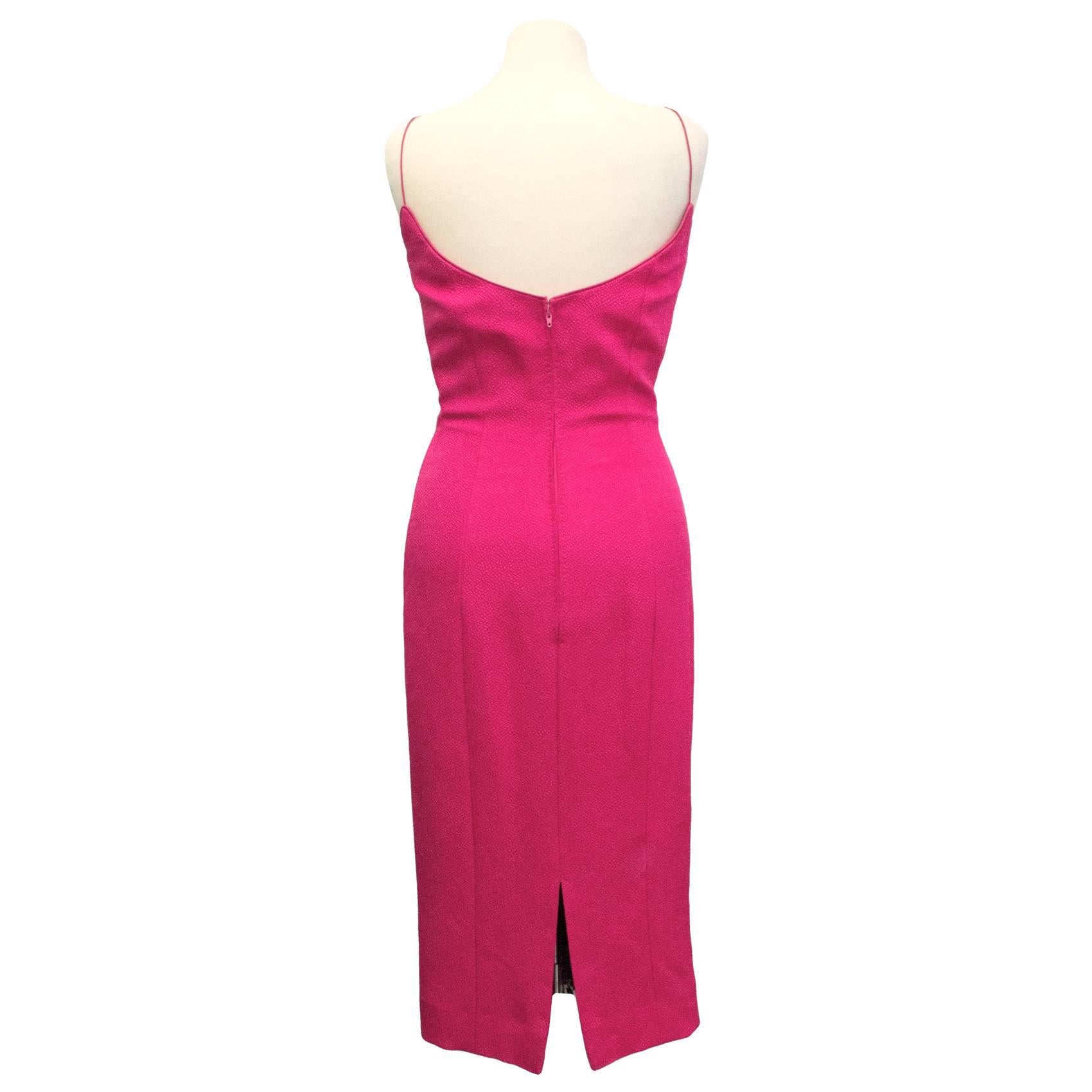 L'Wren Scott below the knee jacquard dress with scooped neckline in fuchsia. Lined in a spandex mix fabric and fastened with a concealed zip at the back and a hook and eye clasp. Small slit in back. 

Please note: Slight discolouration of the