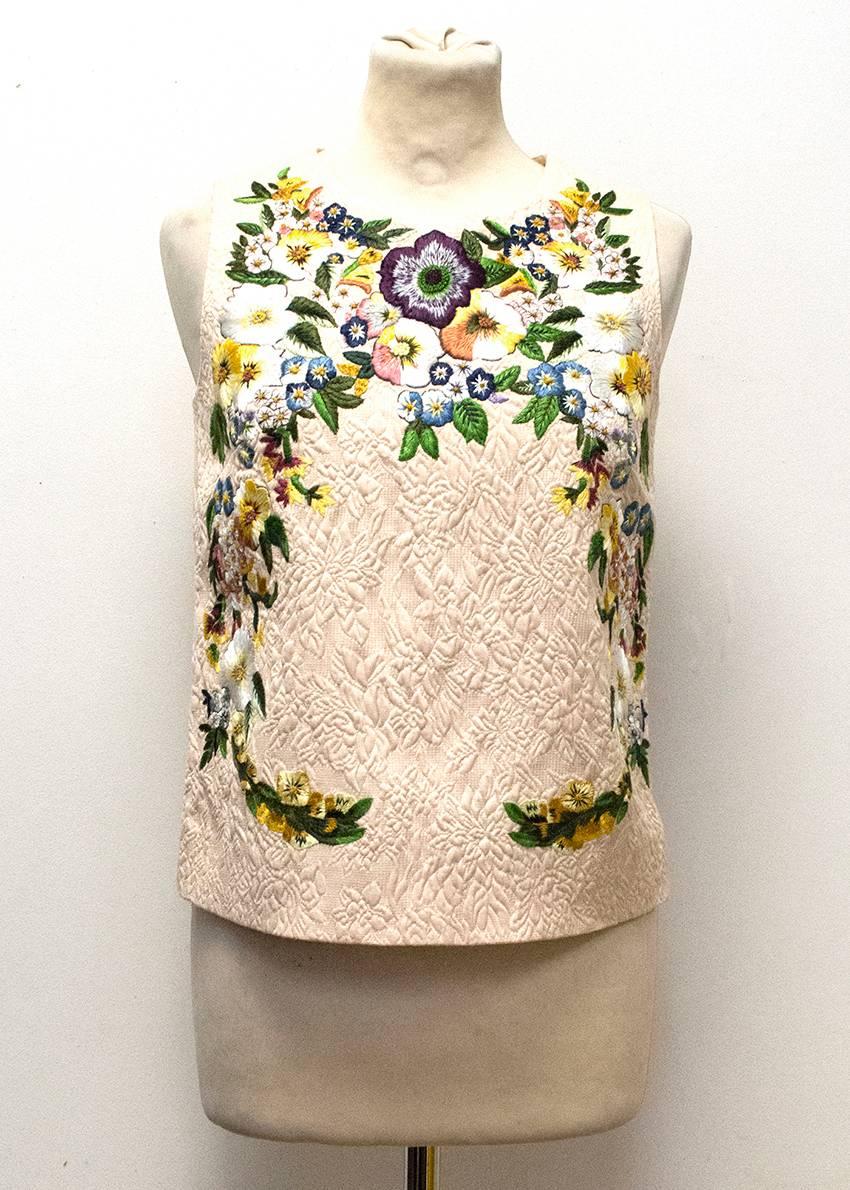 Dolce & Gabbana pale pink floral embroidered sleeveless top.
The top is fully-lined and features a back zipper and embroidered front. 
The top is in excellent condition.

Condition: 9.5/10

91% Cotton, 9% Nylon.
Lining: 98% Silk, 4%Elastane.