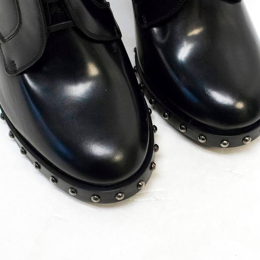 Dolce & Gabbana black leather 'Lawrence' ankle boots. They feature a lace up front fastening, rounded toes, chunky block heels and gunmetal studs around the midsoles. 

Condition: 10/10

Approx measurements: 
Toe To Heel: 23cm 
Width: 9cm