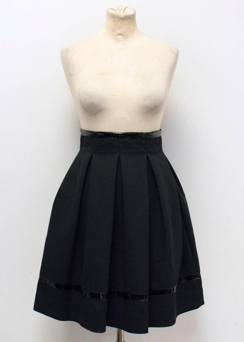 Tamara Mellon black pleated skirt with patent leather trim around the bottom and the waist. Concealed zip closure at the back. 

Conditions Details : Condition: 9.5/10

Approx measurements: 
Waist - 32cm 
Total Length - 57cm