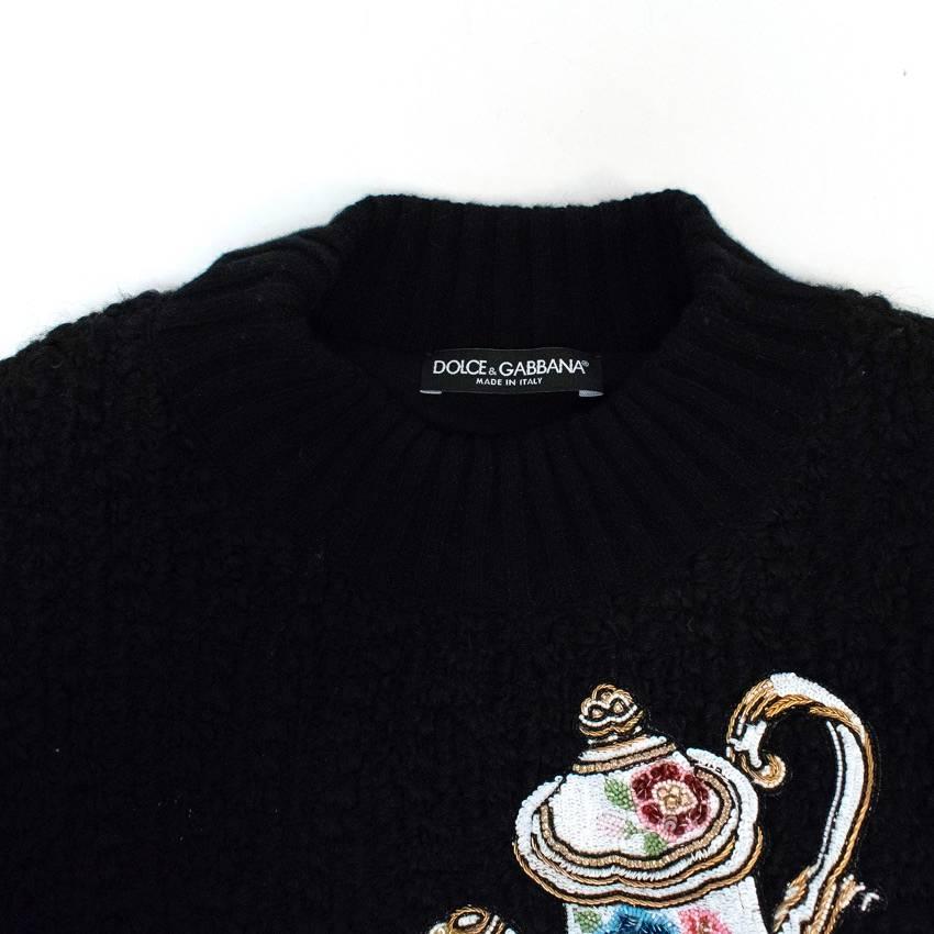 Dolce & Gabbana cropped black boucle jumper with a round neck, ribbed cuffs and neckline. Embellished with a sequin tea pot and tea cup decal. Fully lined.

Condition: 10/10

Approx measurements: 
Shoulders - 42cm 
Chest - 50cm 
Waist - 51cm